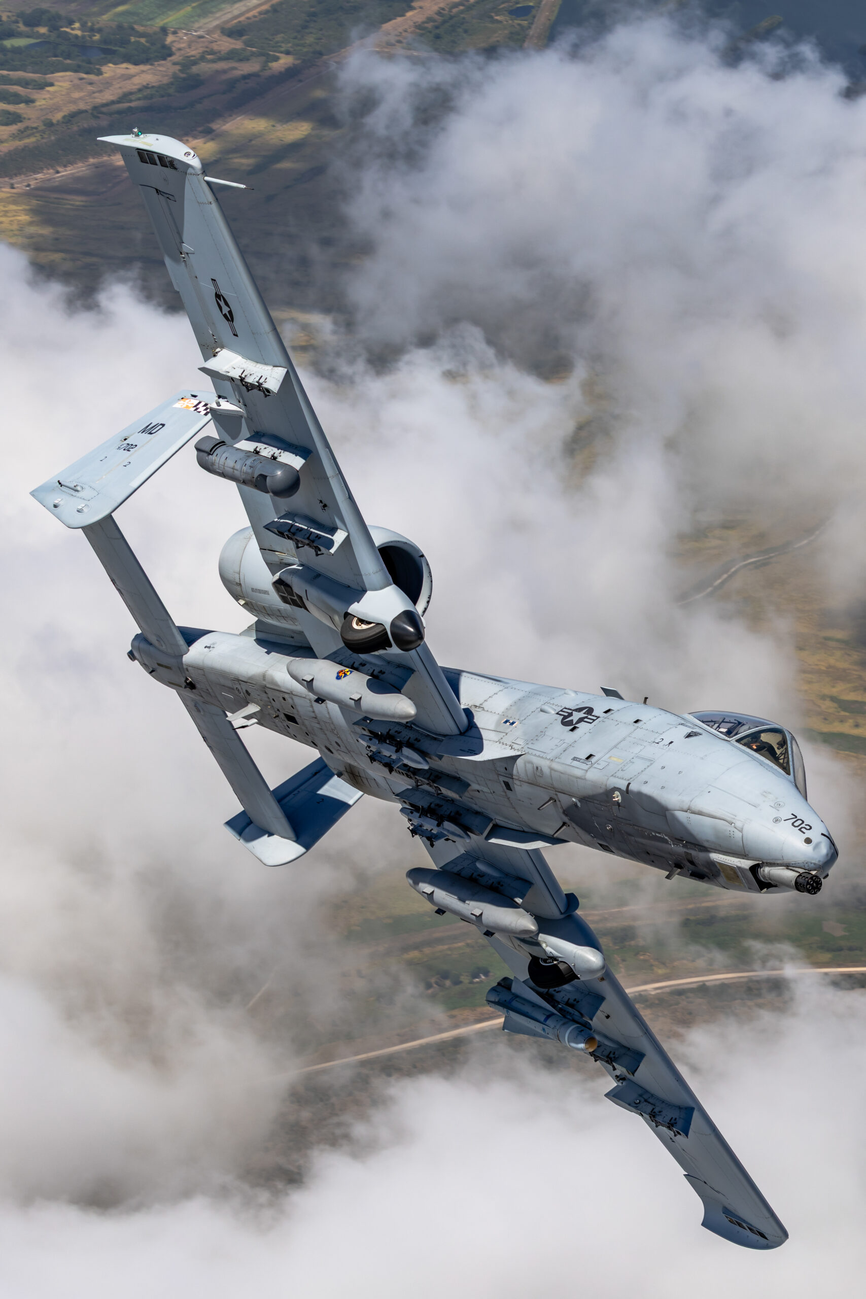 Topside view of A-10C 78-0702 banking hard, Maryland flag checkerboard on the tail