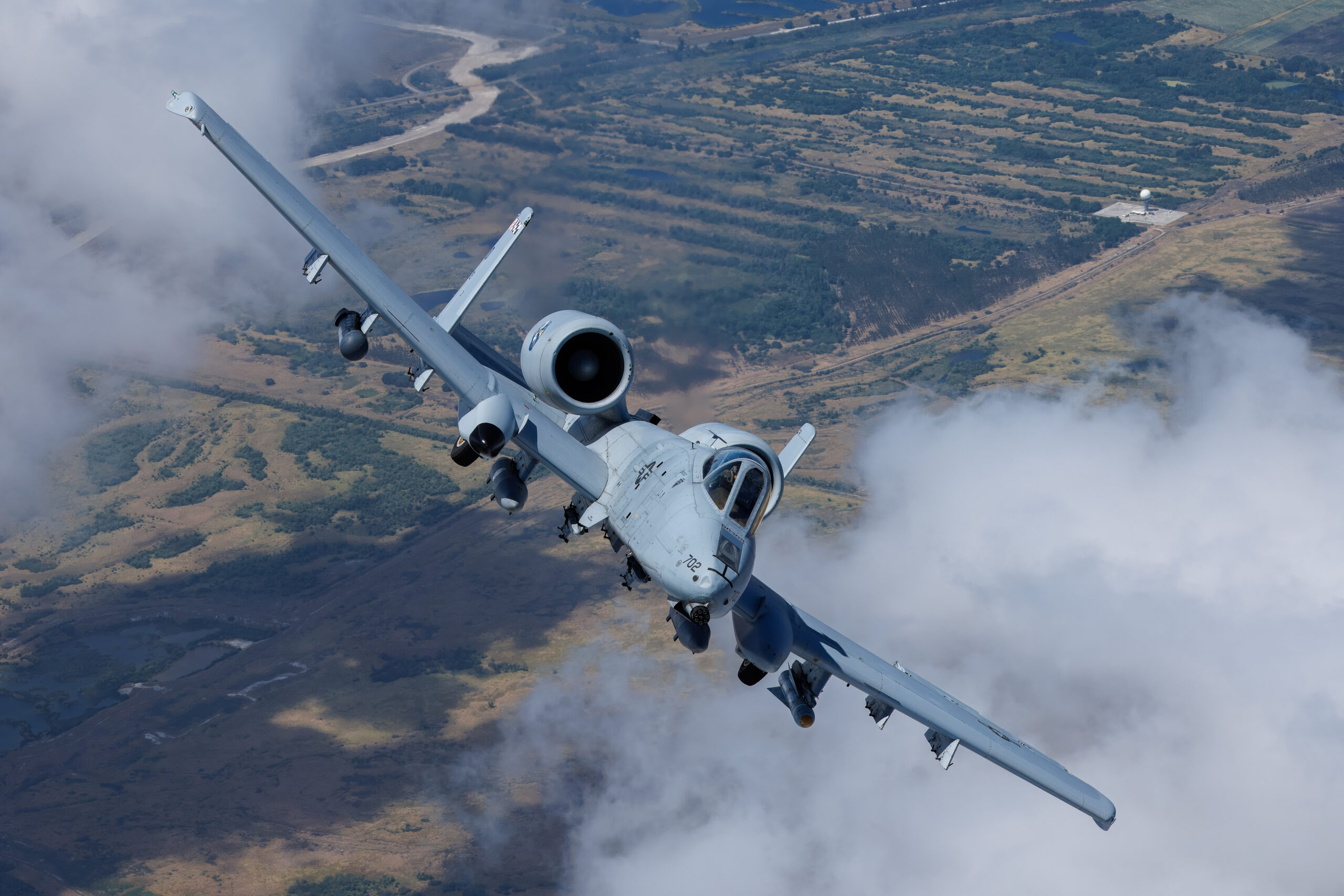 A-10C 78-0702 banking towards the camera over broken cloud