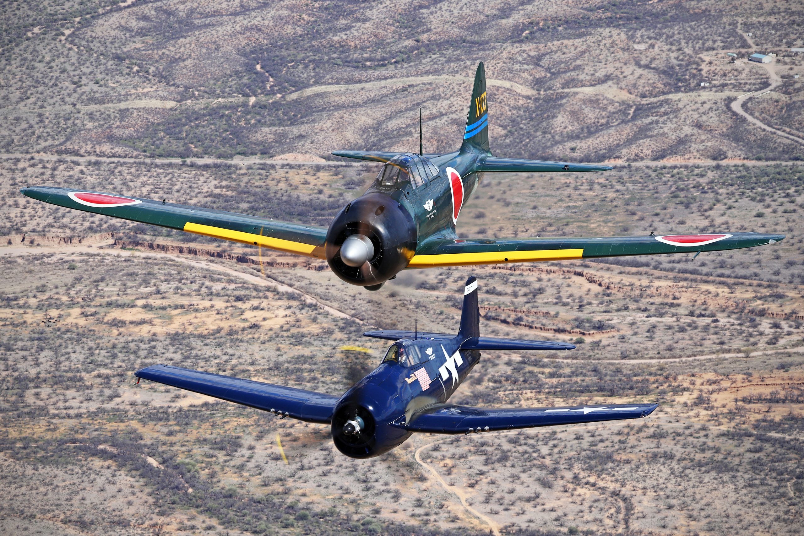 Mitsubishi A6M3 Zero in formation with a Grumman F6F-5 Hellcat, air to air