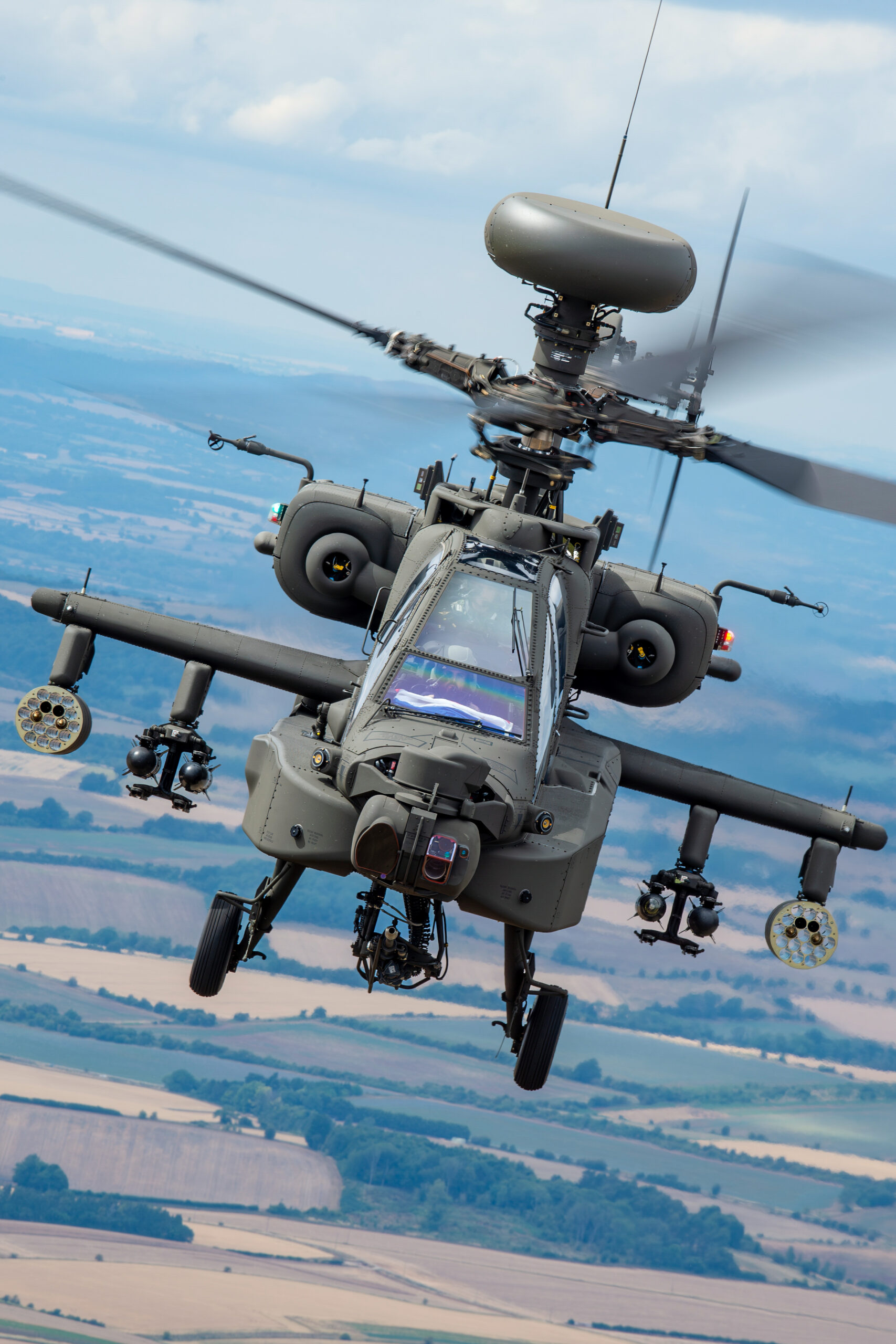 Close-up of a Royal Netherlands Air Force AH-64E Apache Guardian rotor head and radar dome in flight