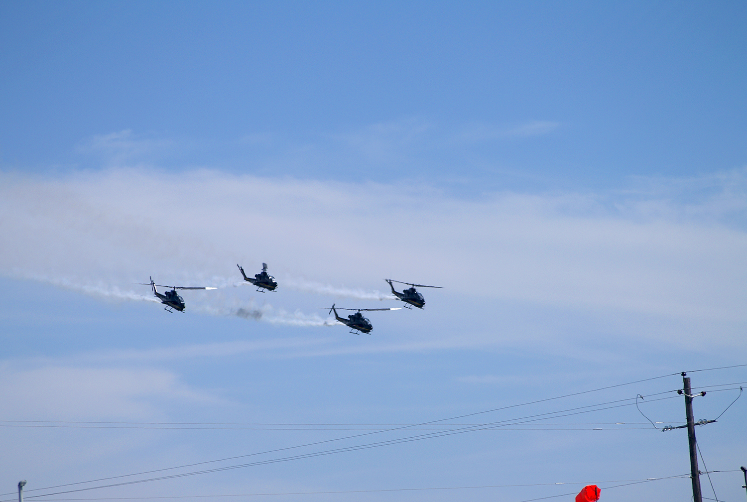 US Army Sky Soldiers demonstration team AH-1 Cobras flying with smoke at an airshow