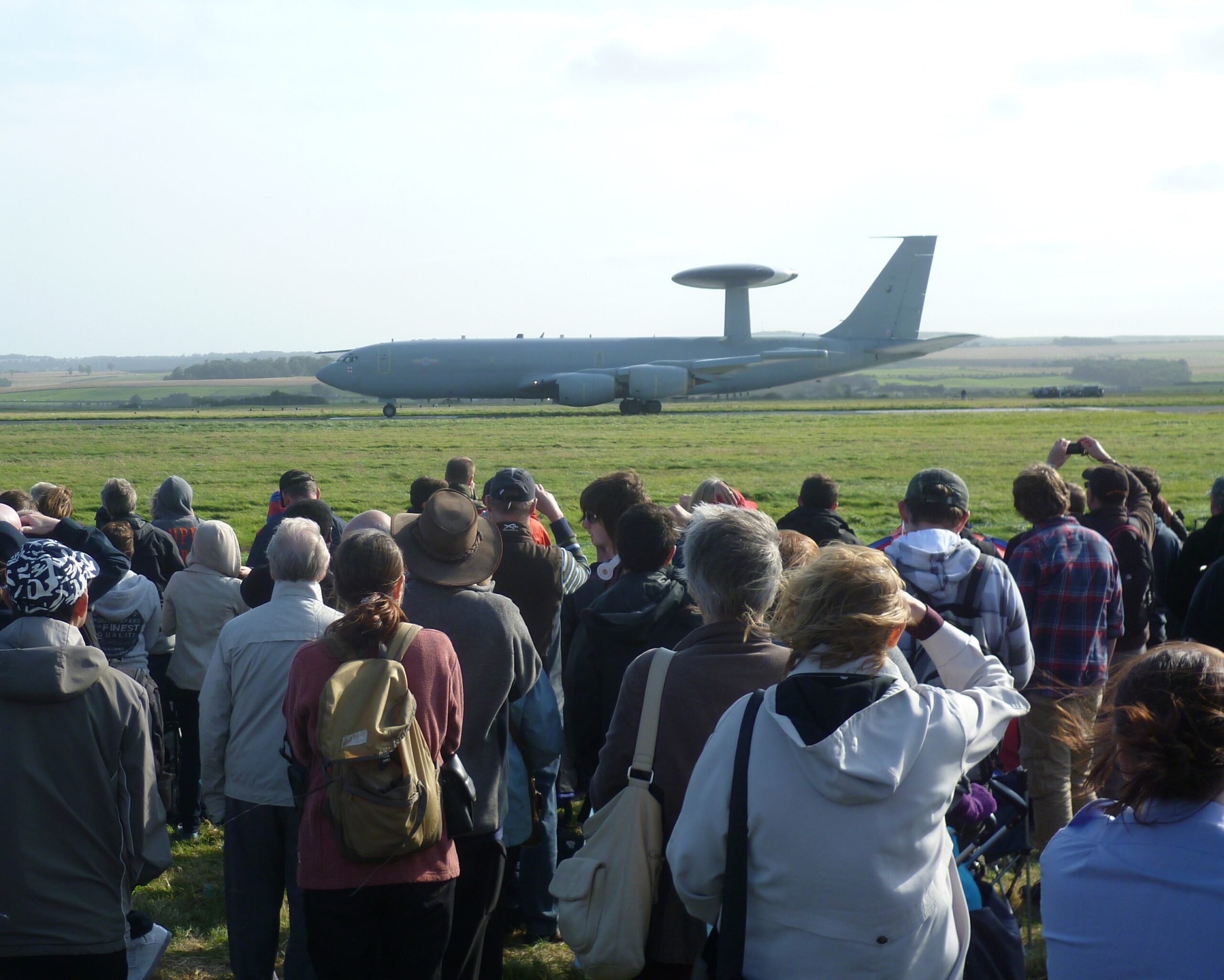 A line of photographers and spectators with cameras at the Leuchars Airshow