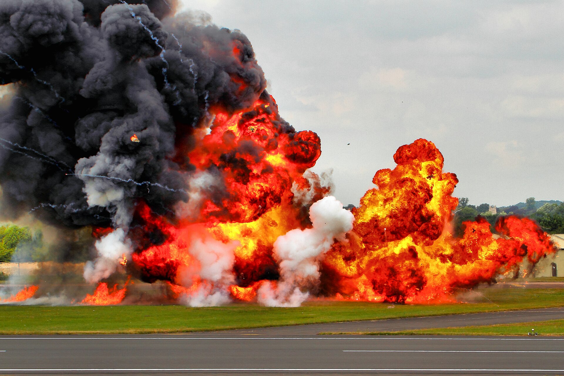 Pyrotechnics erupting during the Apache AH-64D role demonstration at RIAT 2014