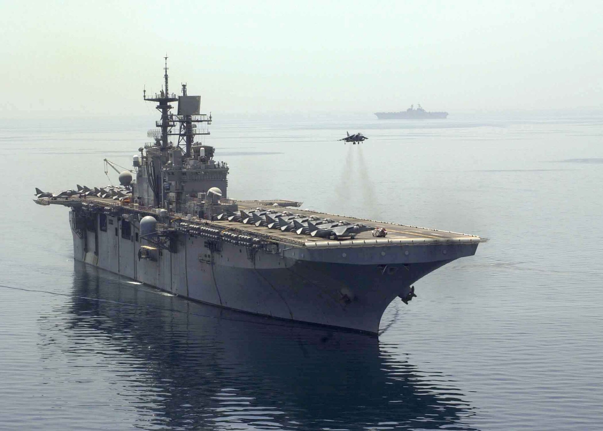 AV-8B Harrier hovering above the flight deck of the amphibious assault ship USS Bataan, April 2003