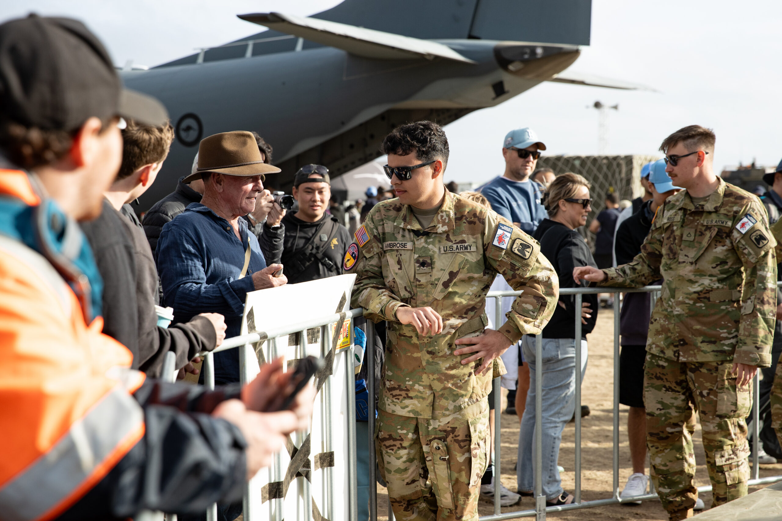 A U.S. Army soldier shows the AH-64E to a crowd at the 2025 Avalon Australian International Airshow