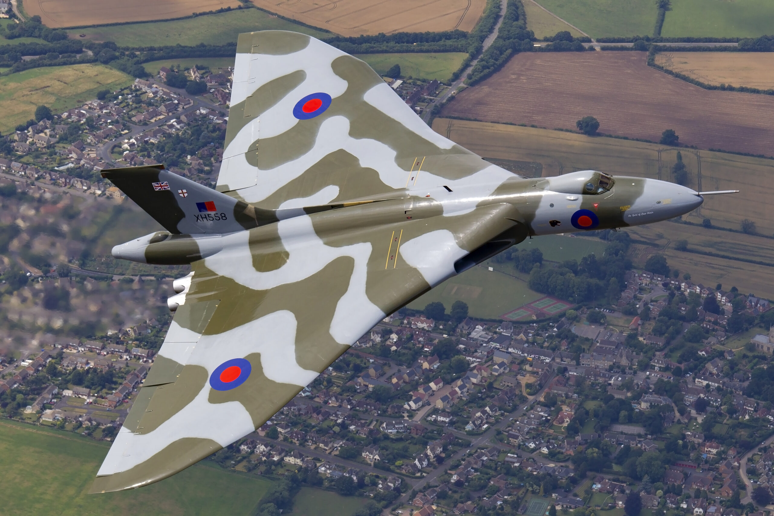 Avro Vulcan B.2 XH558 Spirit of Great Britain banking with the tail code XH558 visible, photographed air to air