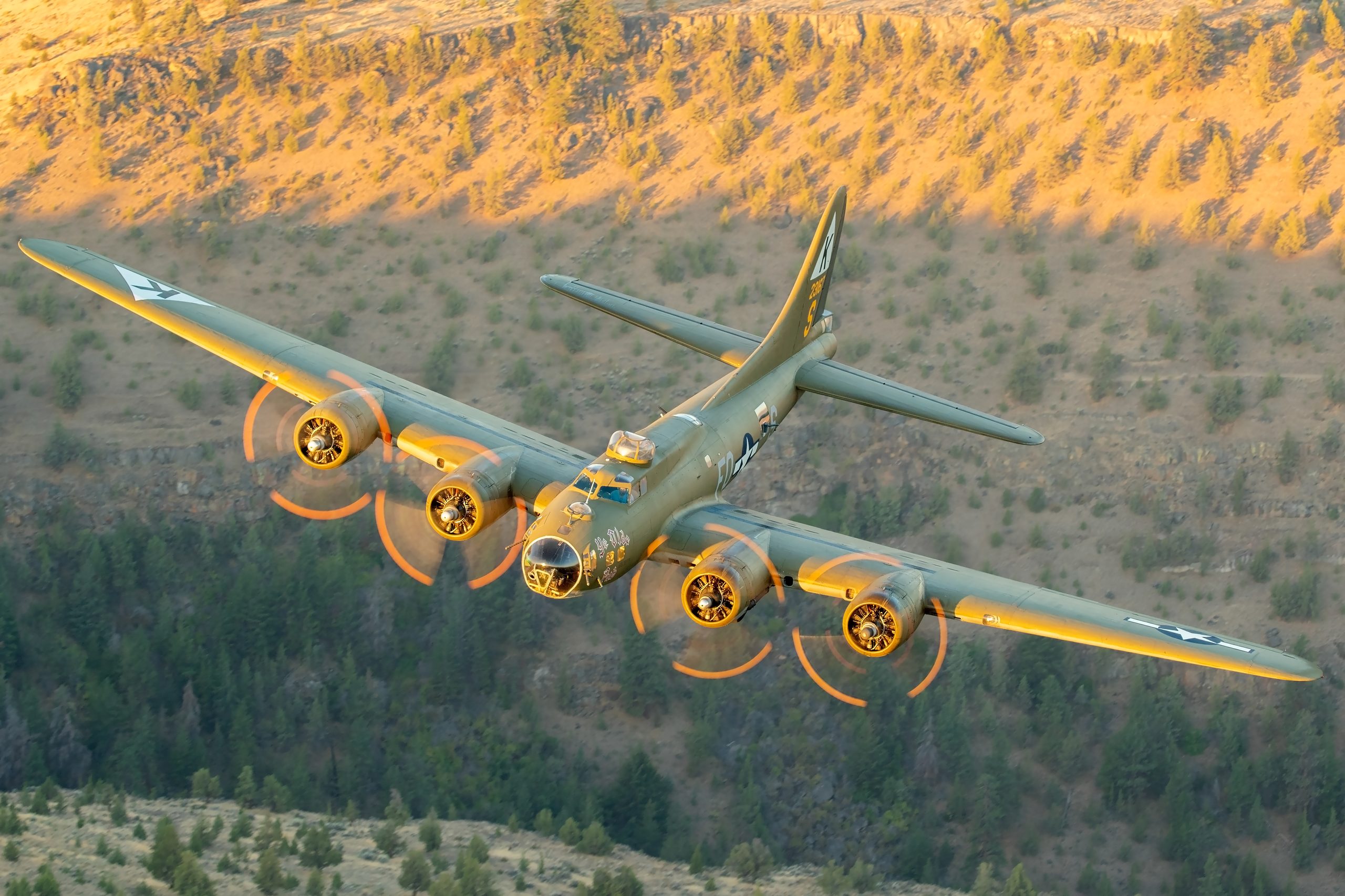 B-17 Flying Fortress Ye Olde Pub front quarter over forested hills, air to air