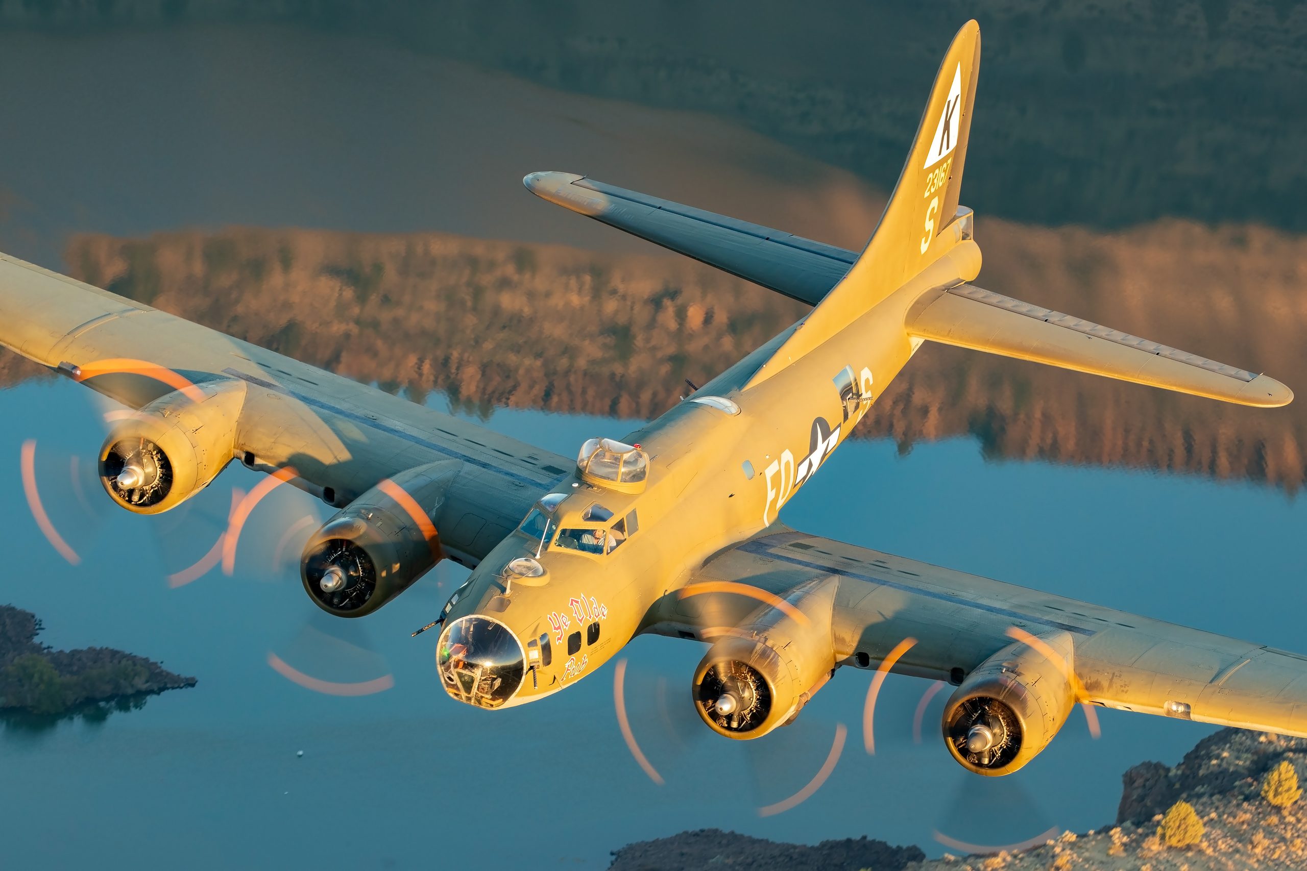 B-17 Flying Fortress Ye Olde Pub front quarter over an Oregon lake, air to air