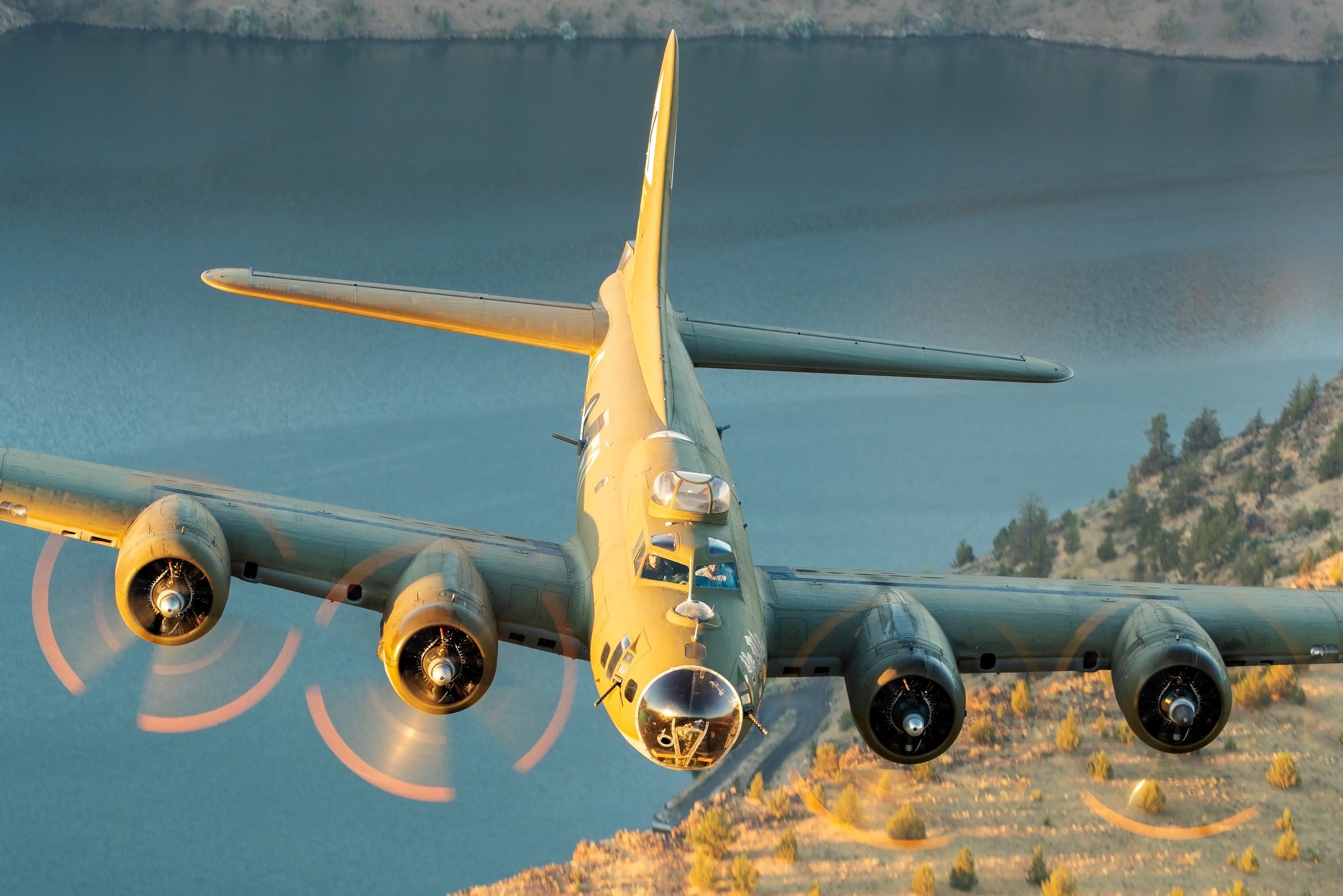 B-17 Flying Fortress Ye Olde Pub head on in golden light over water, air to air