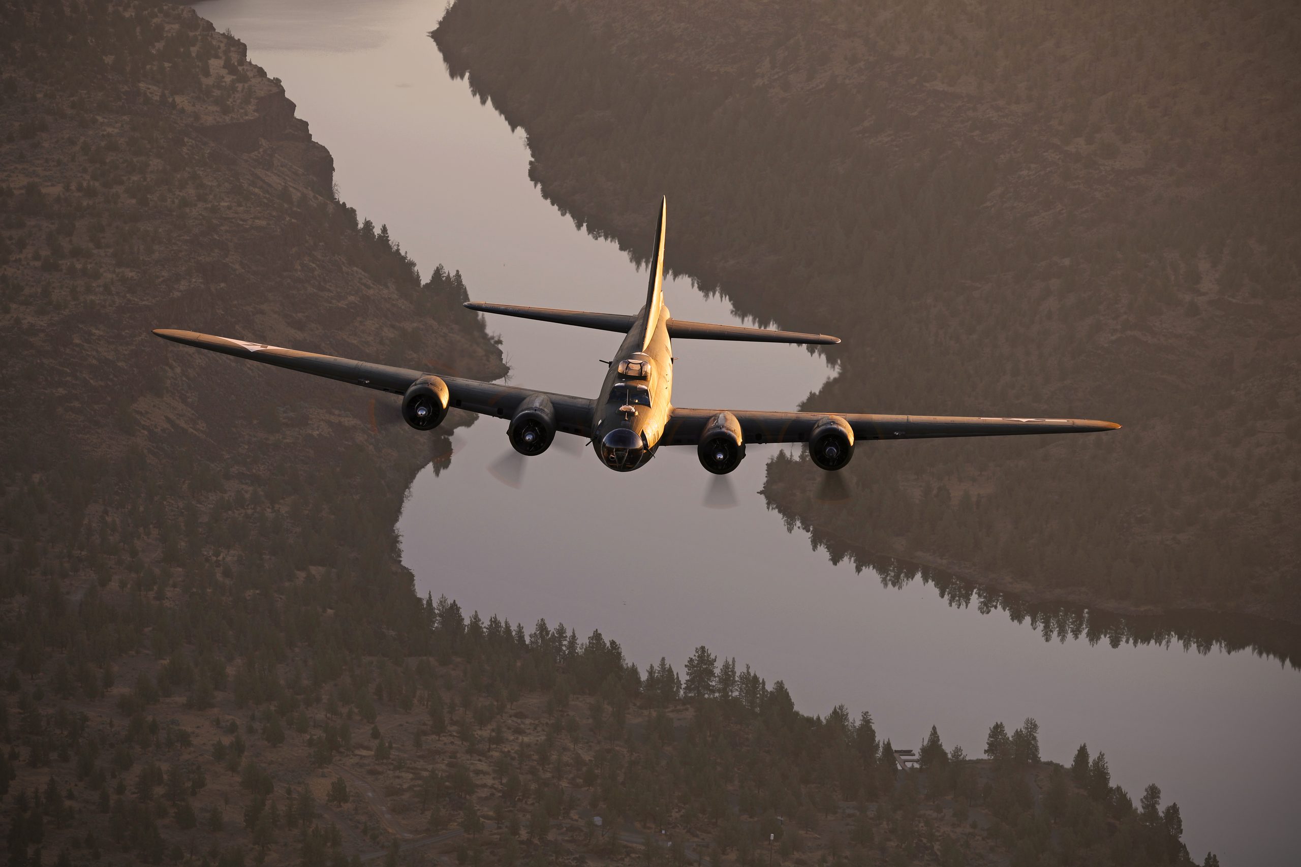 B-17 Flying Fortress Ye Olde Pub head on over a winding river, air to air