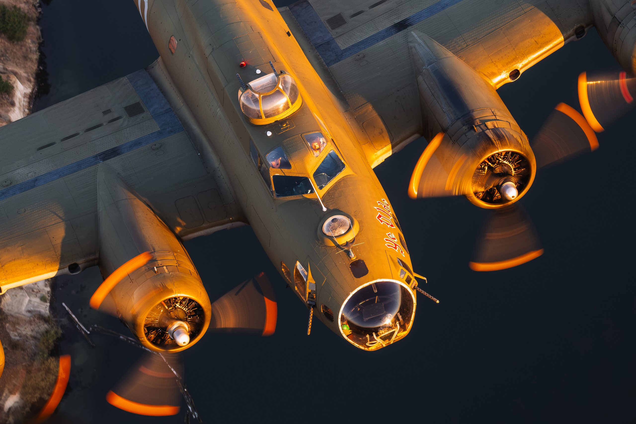 B-17 Flying Fortress Ye Olde Pub nose close up with all four propellers turning in low light