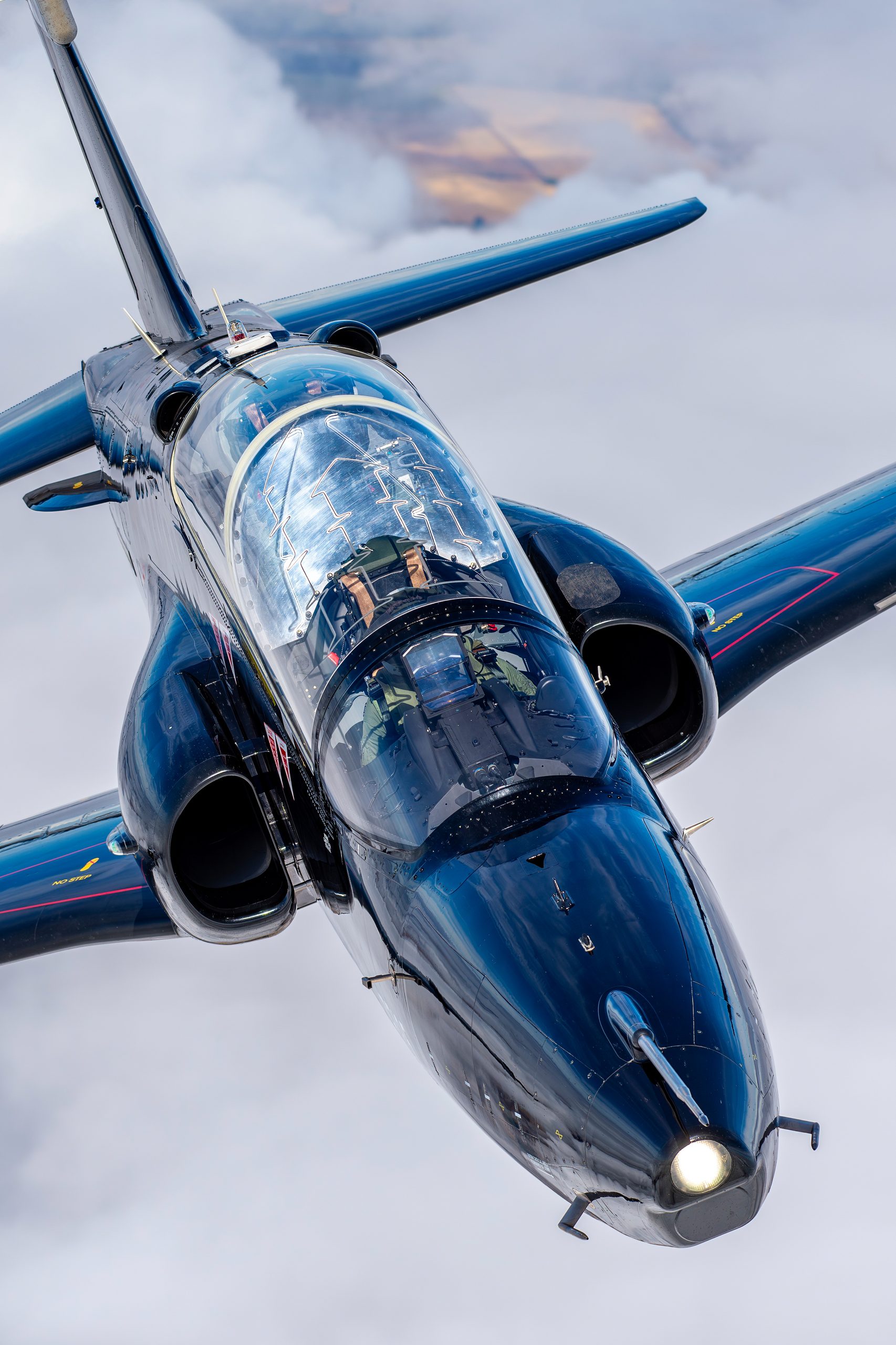 Air-to-air close-up of a BAE Systems Hawk showing the tandem bubble canopy