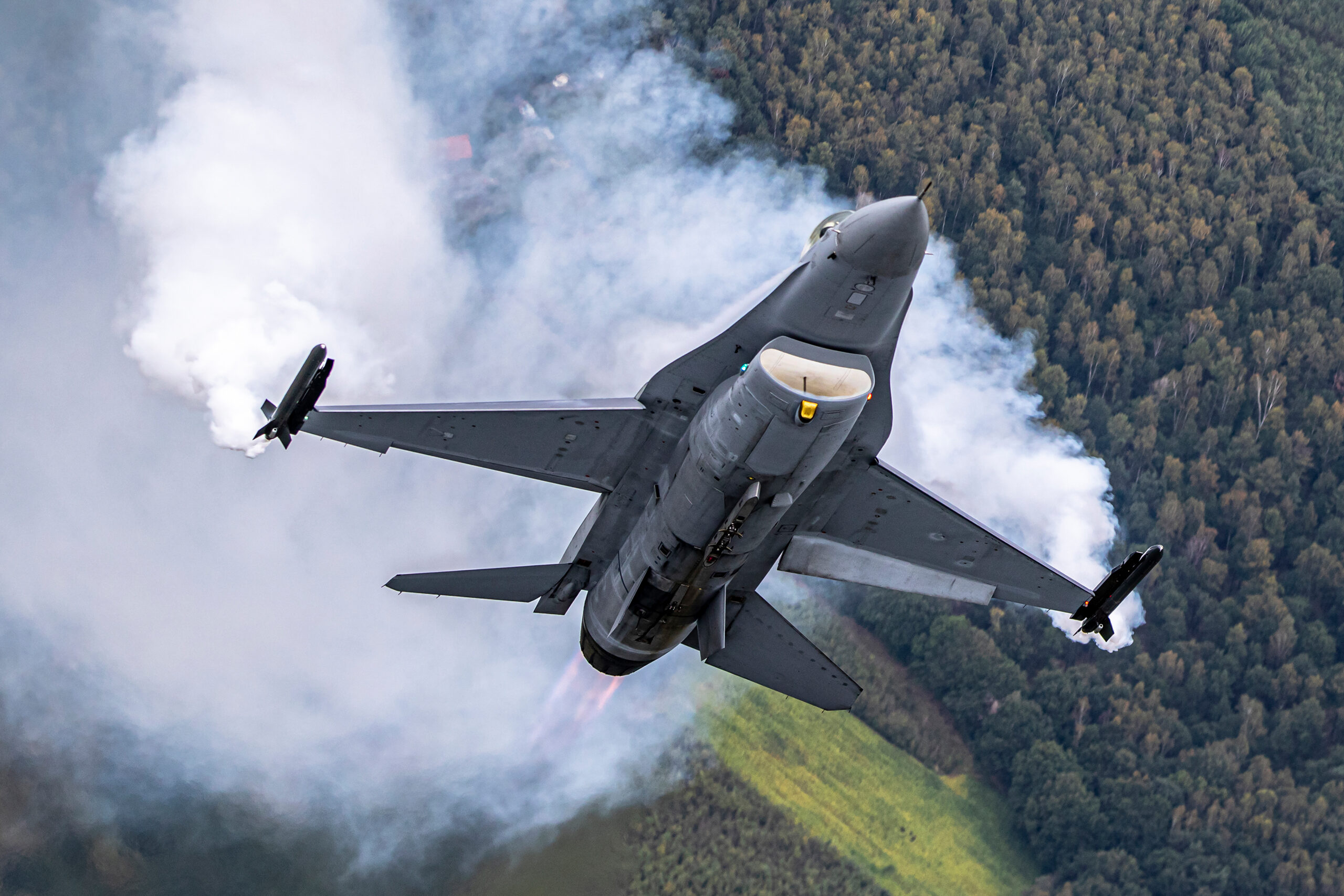 Belgian Air Force F-16 pulling hard with afterburner flame and wingtip vapour