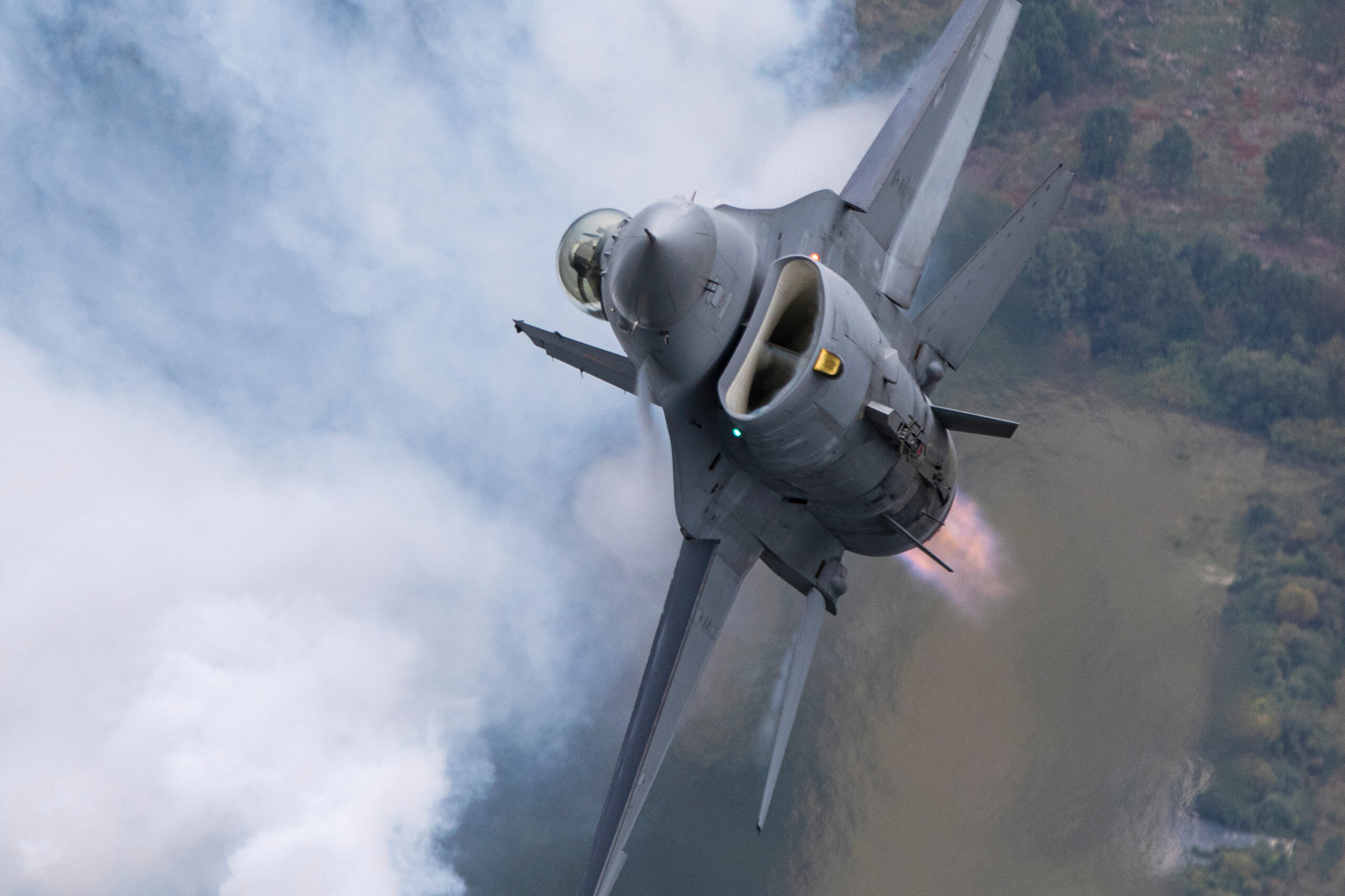 Belgian Air Force F-16 climbing vertically in afterburner with vapour