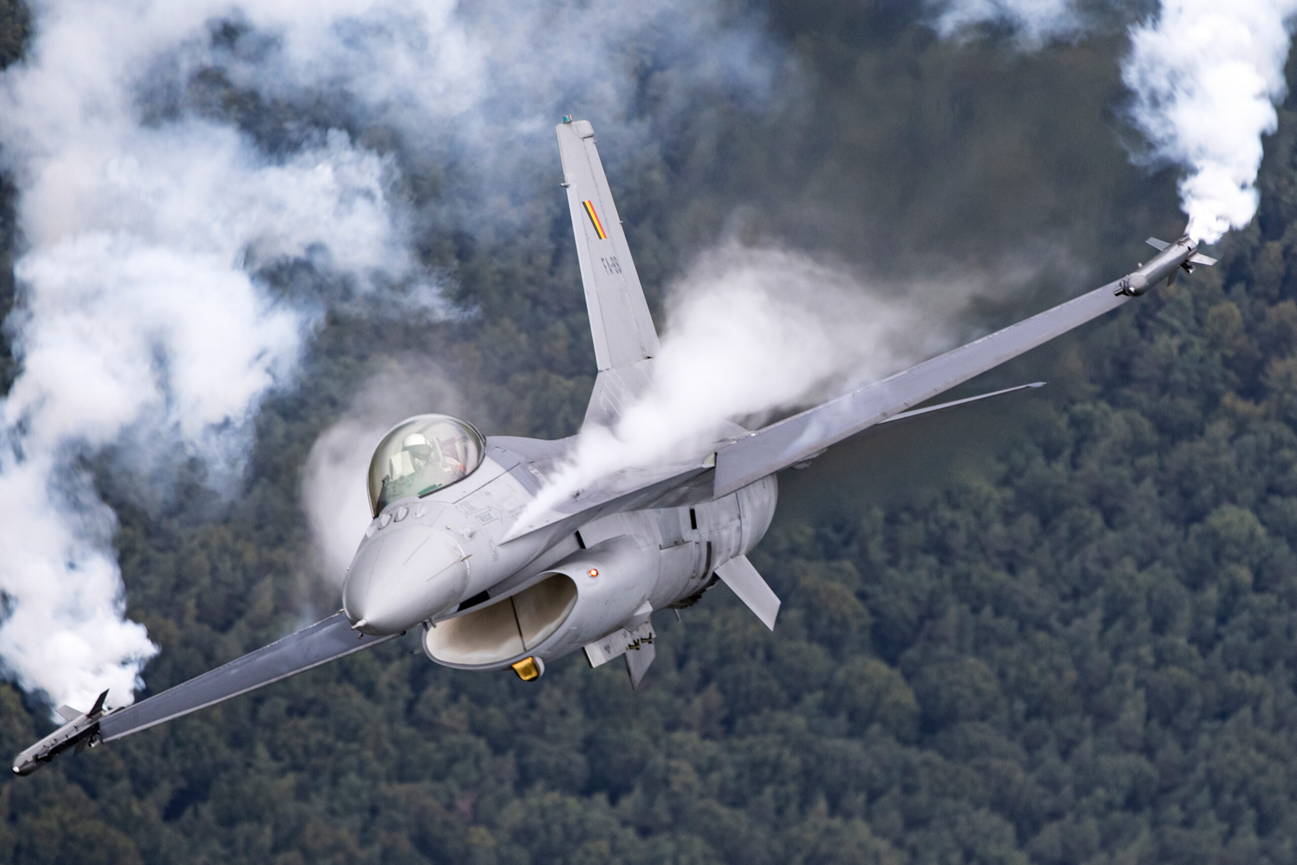 Belgian Air Force F-16 in a hard turn with vapour boiling off the wing root