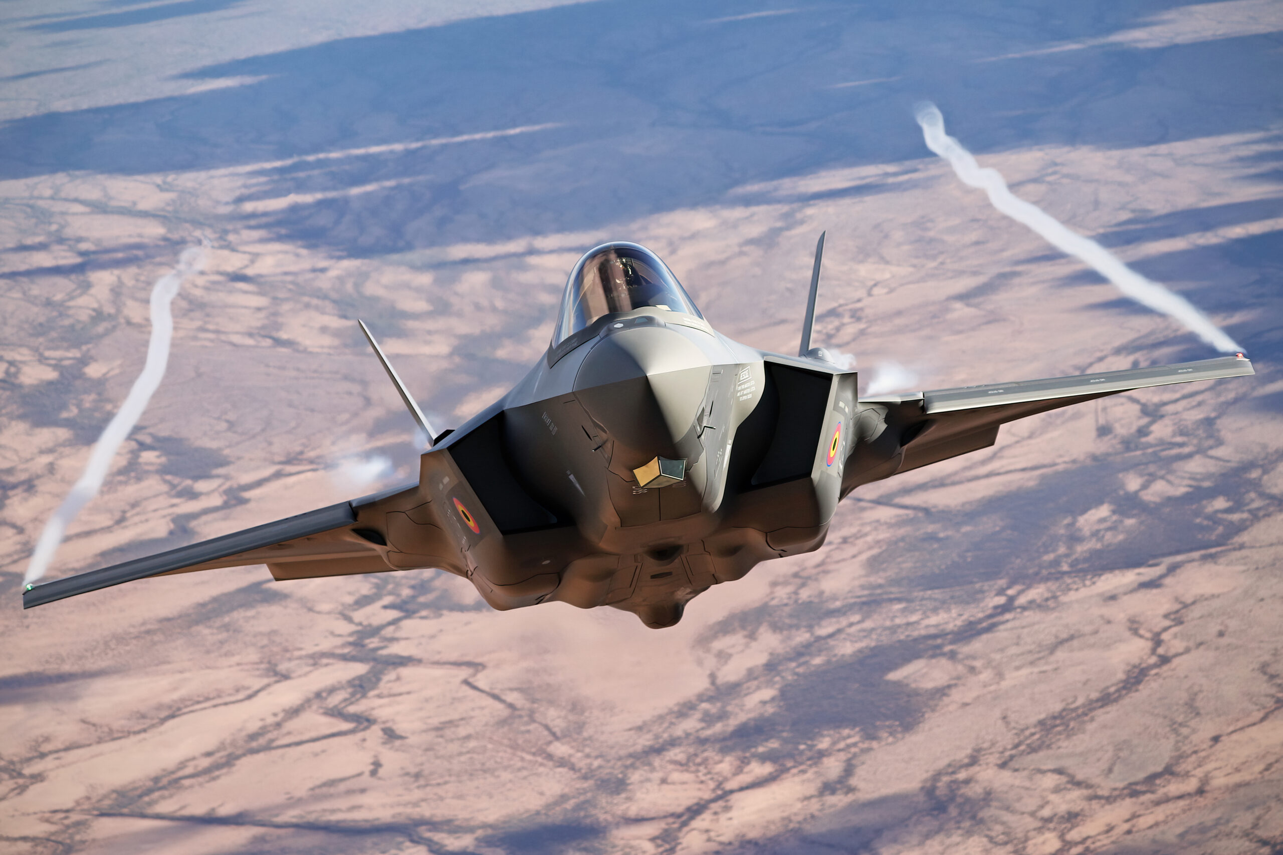 Belgian F-35A head-on pulling wingtip vortices over the desert