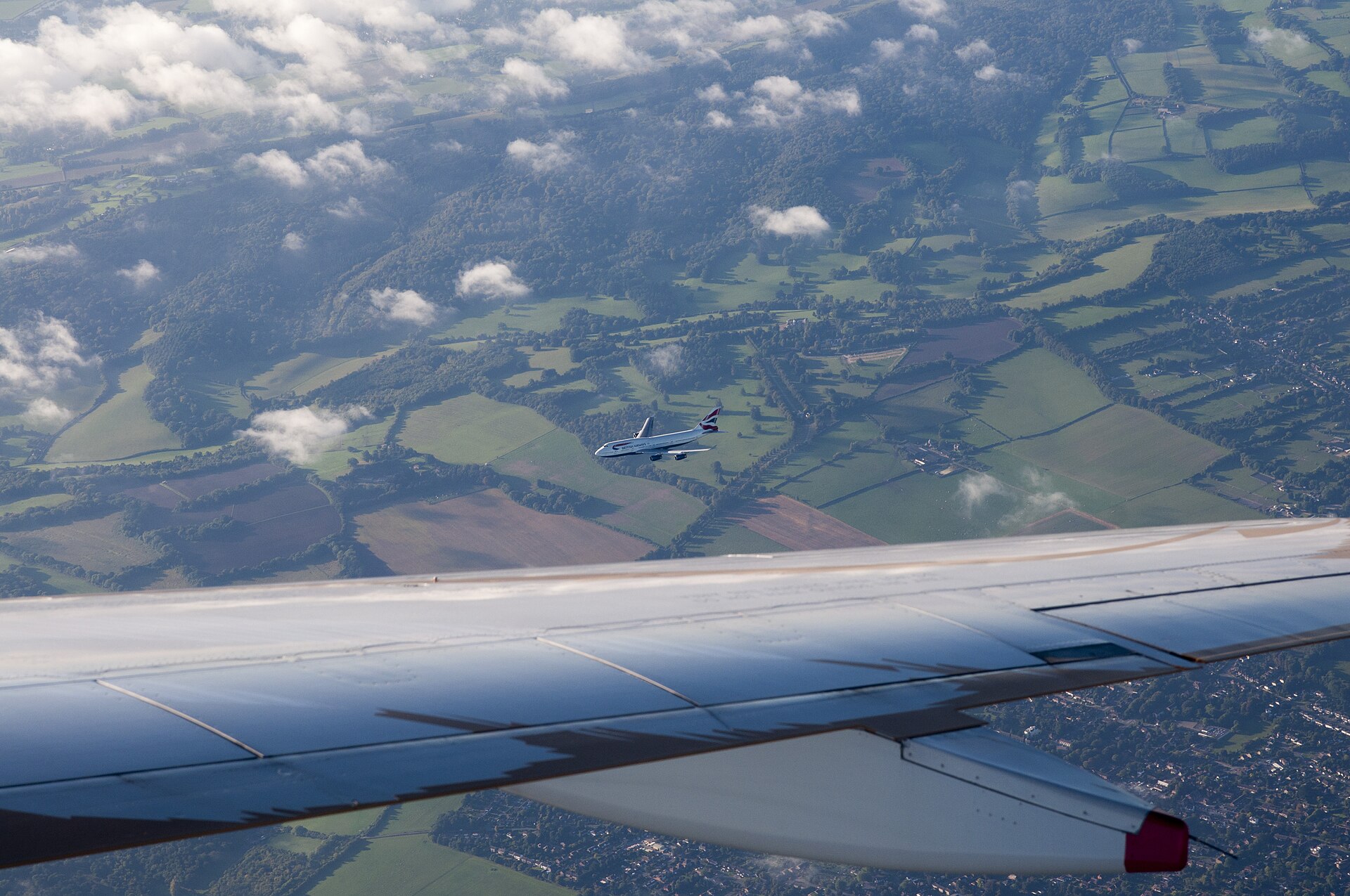 Boeing 747 seen from above on approach to London Heathrow, showing the full wing planform
