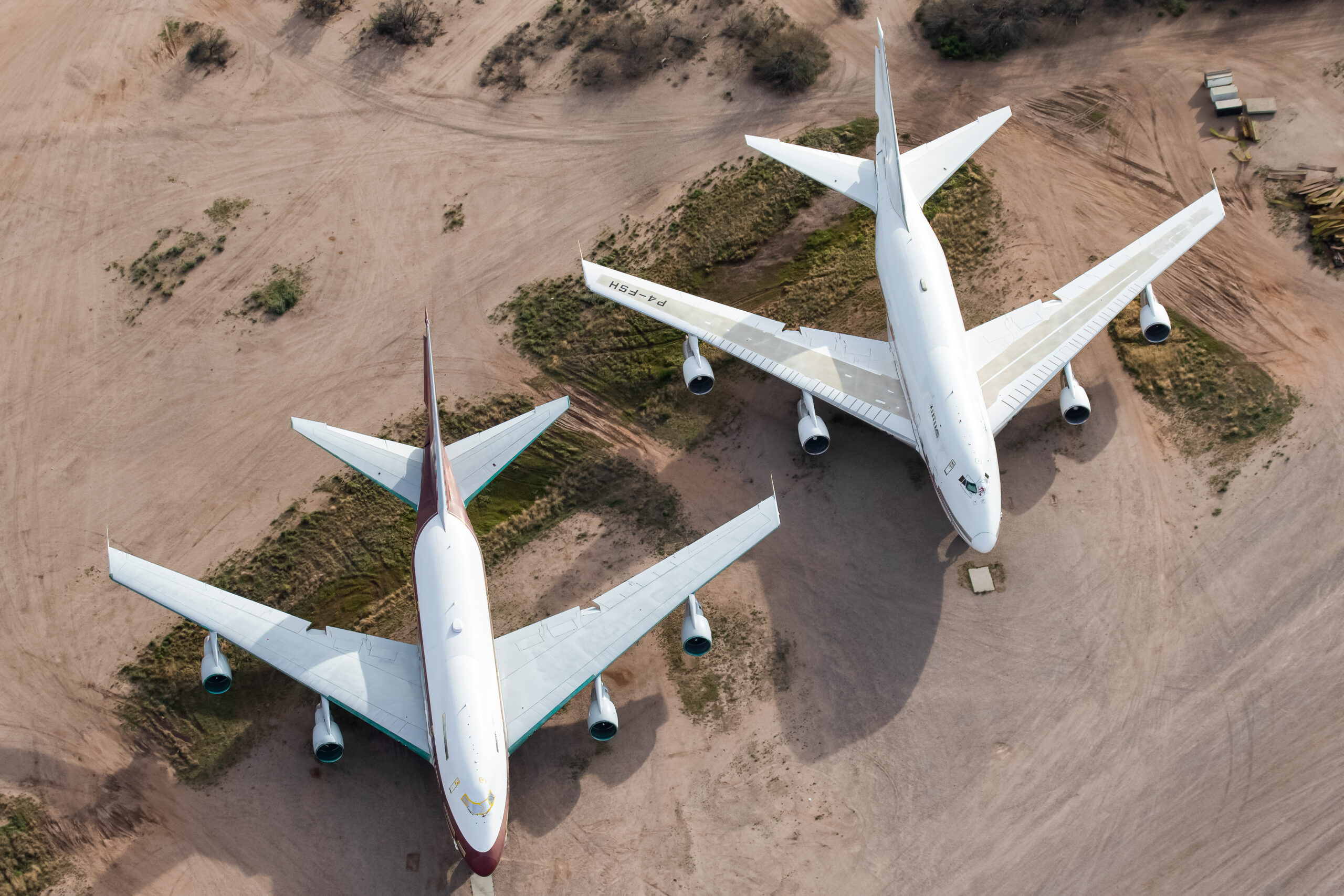 Top-down aerial view of Boeing 747SP-31 P4-FSH and 747SP-21 VP-BAT stored in the desert at Pinal Airpark
