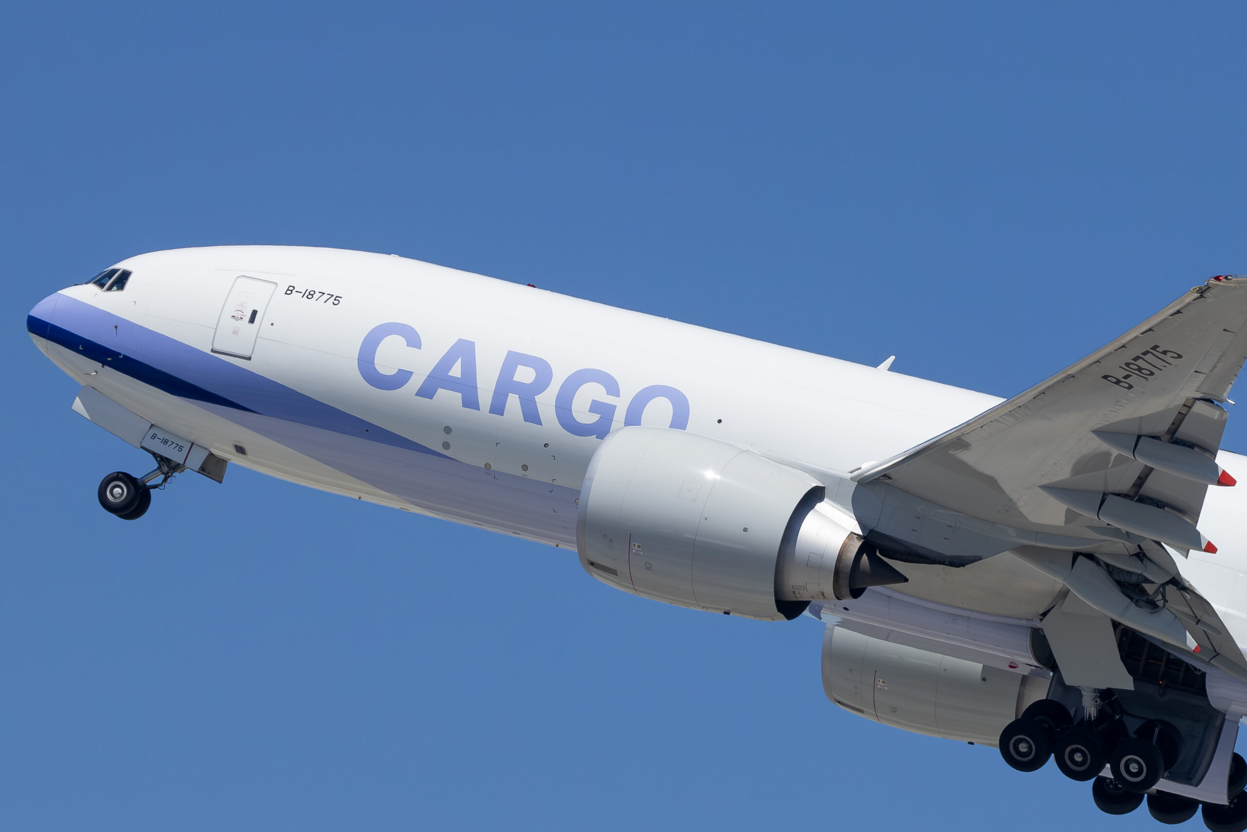 Boeing 777 freighter climbing out with registration B-18775 visible on nose and tail
