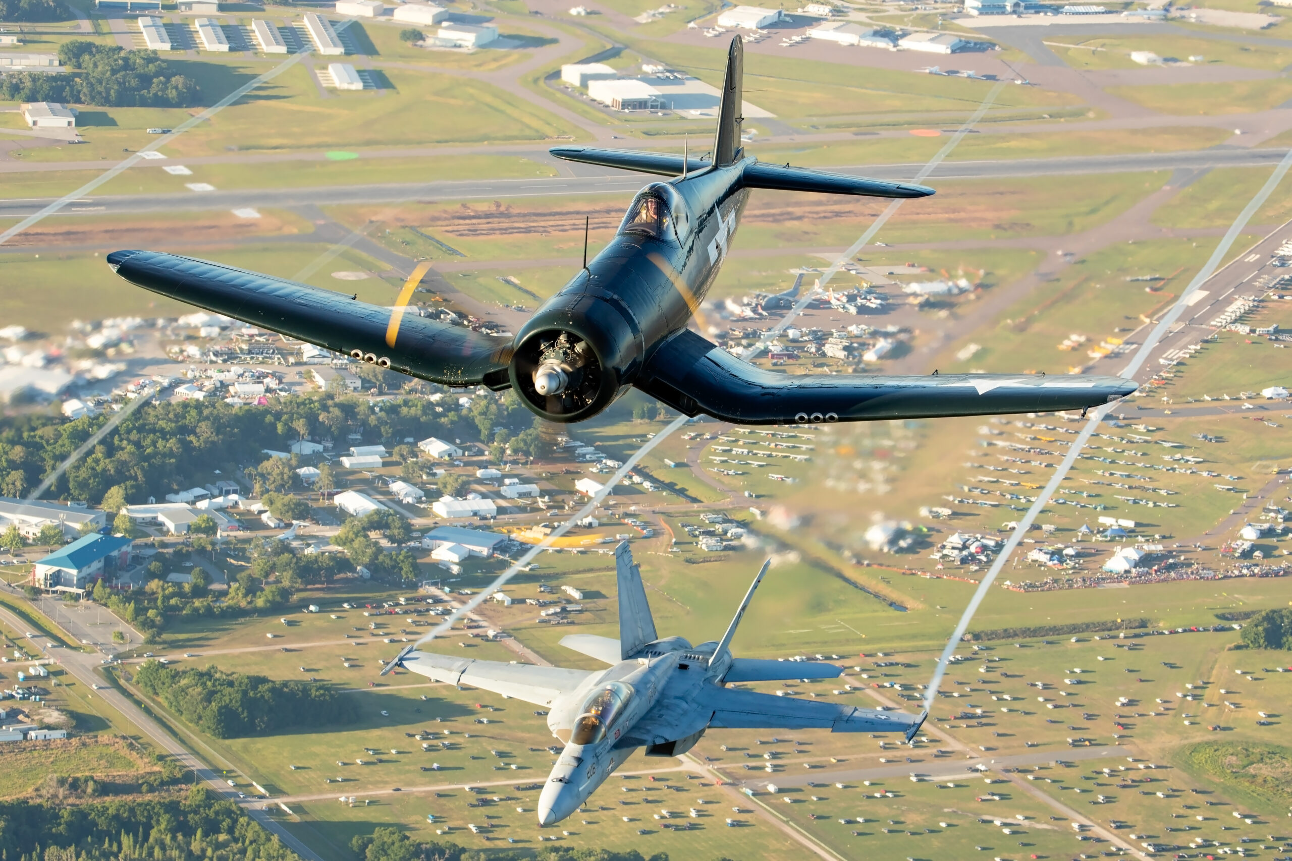 Goodyear FG-1D Corsair banking with an F/A-18F Super Hornet flying below