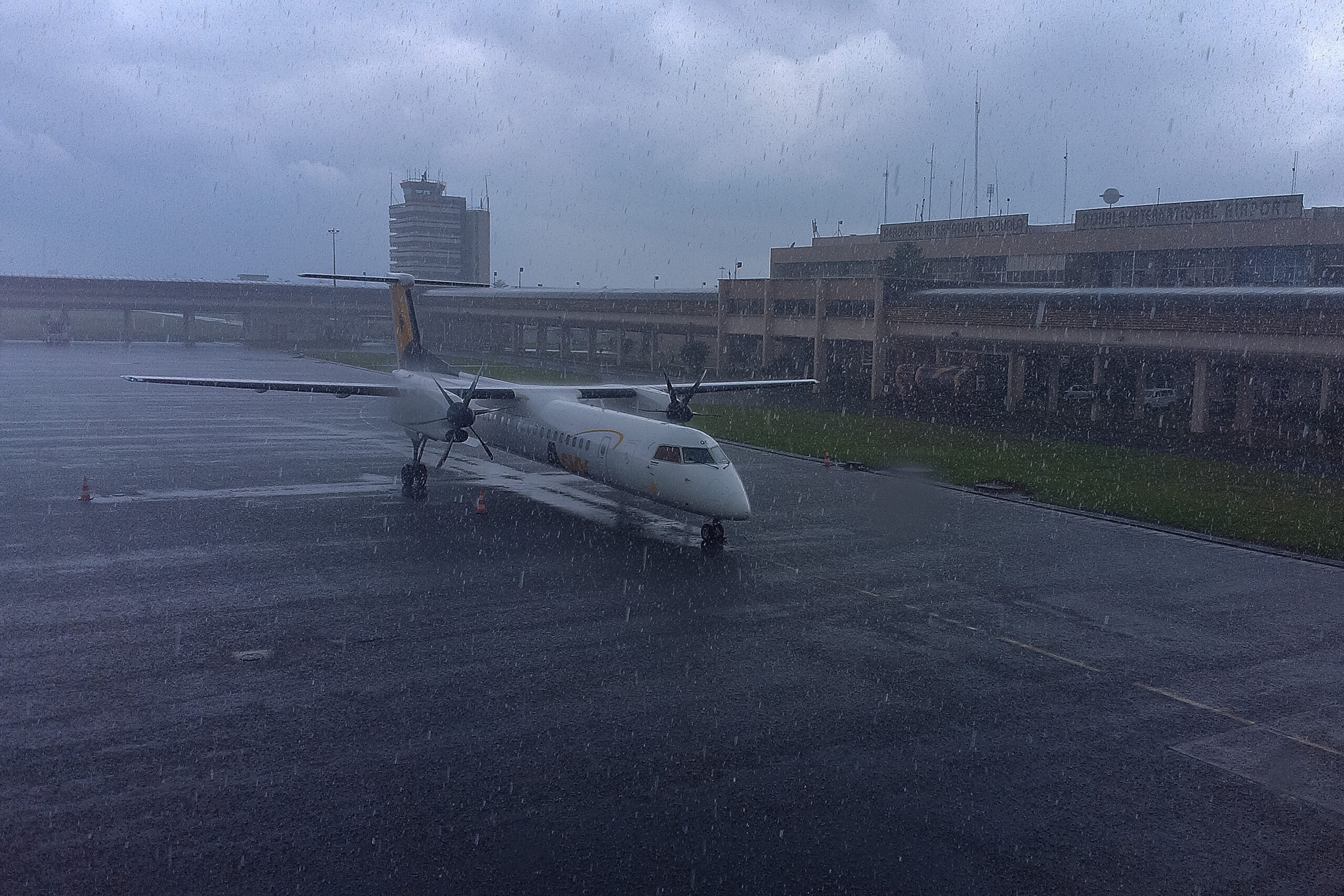 A Dash 8 Q400 airliner in heavy tropical rain