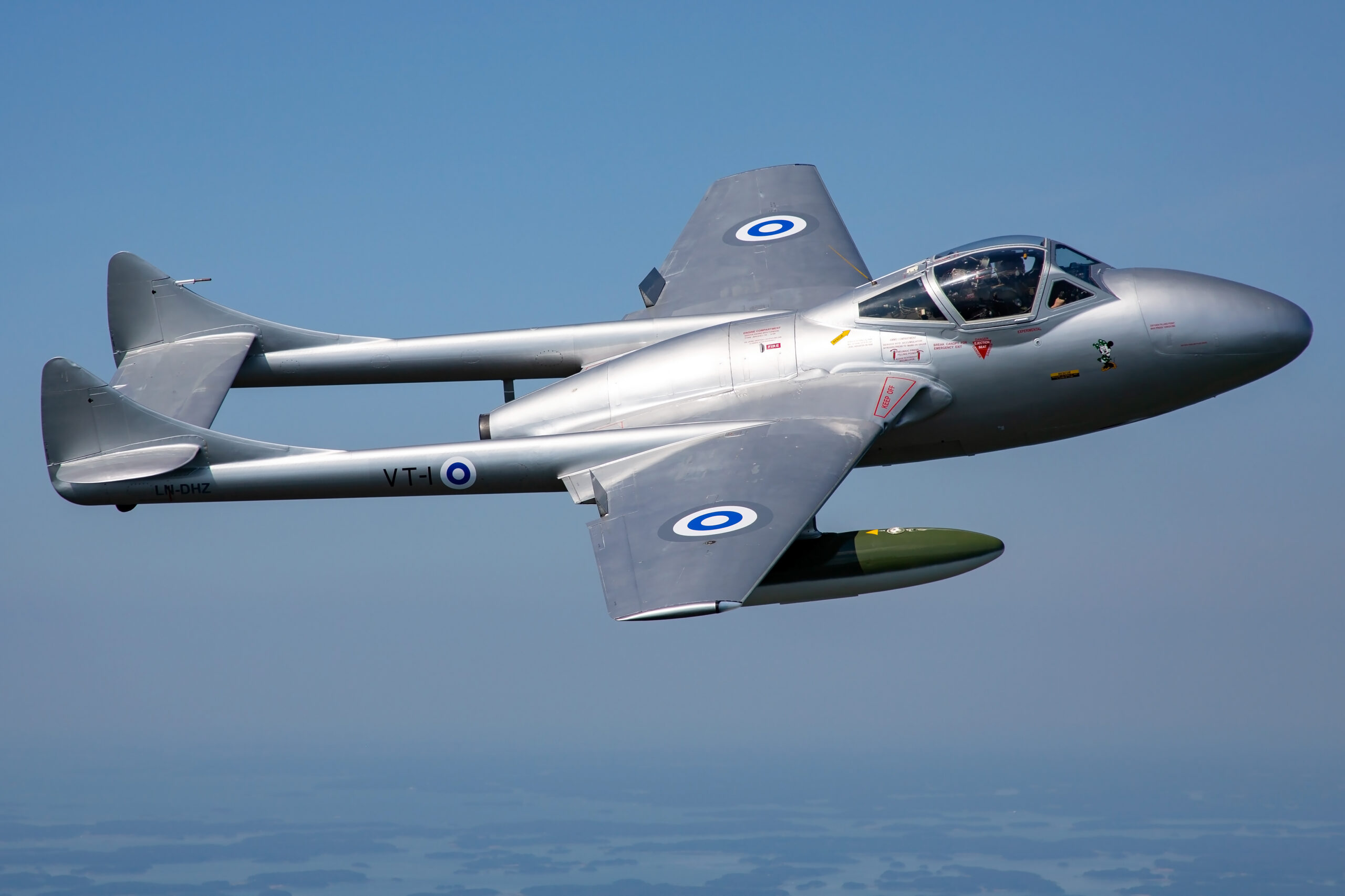 Silver De Havilland Vampire T55 in Finnish Air Force markings, code VT-1, side-on against a clear blue sky