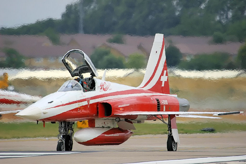 Patrouille Suisse display team flying in formation at distance at the RIAT airshow