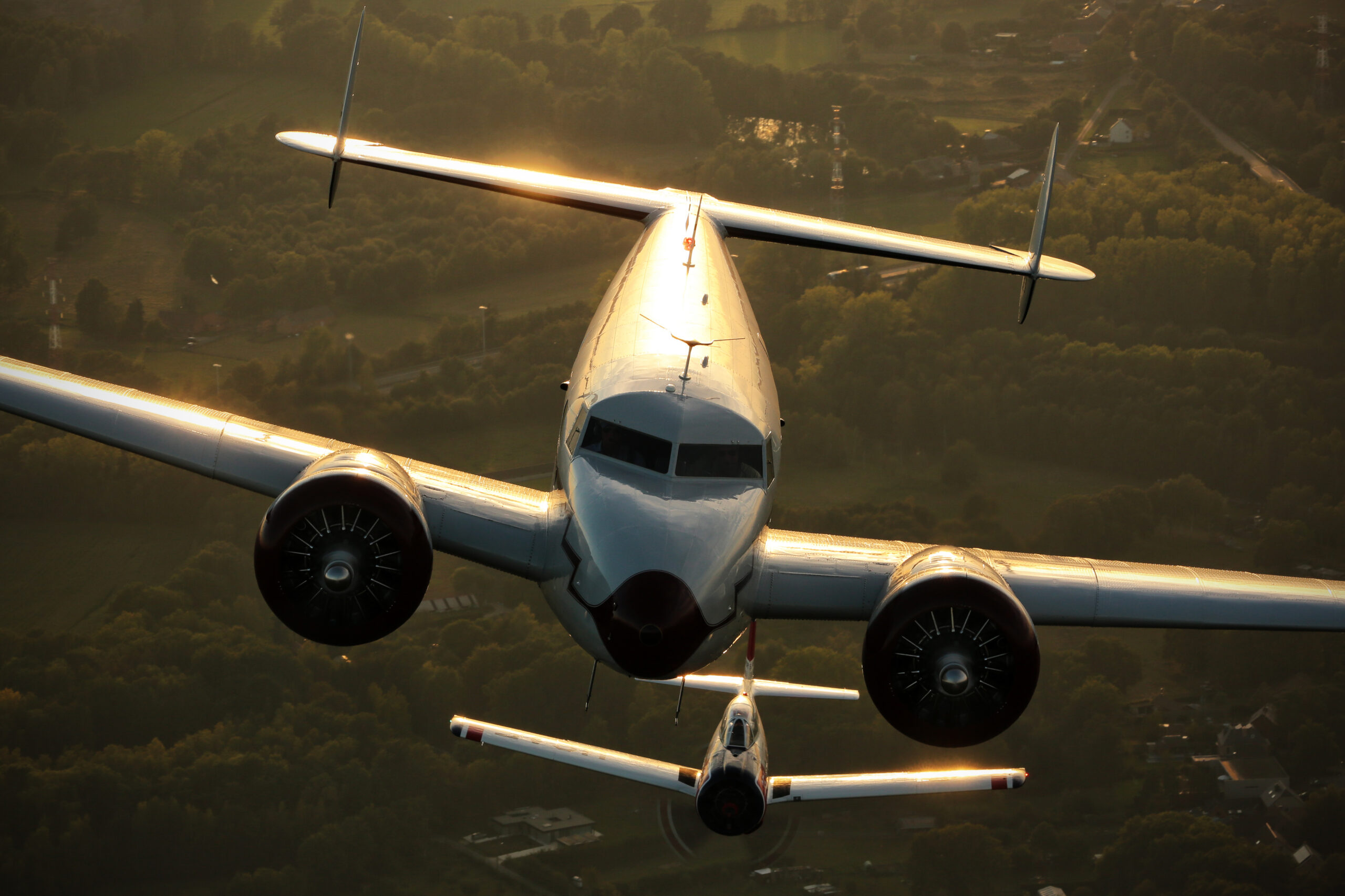 Lockheed 12 Electra Junior and T-28B in golden hour rim light