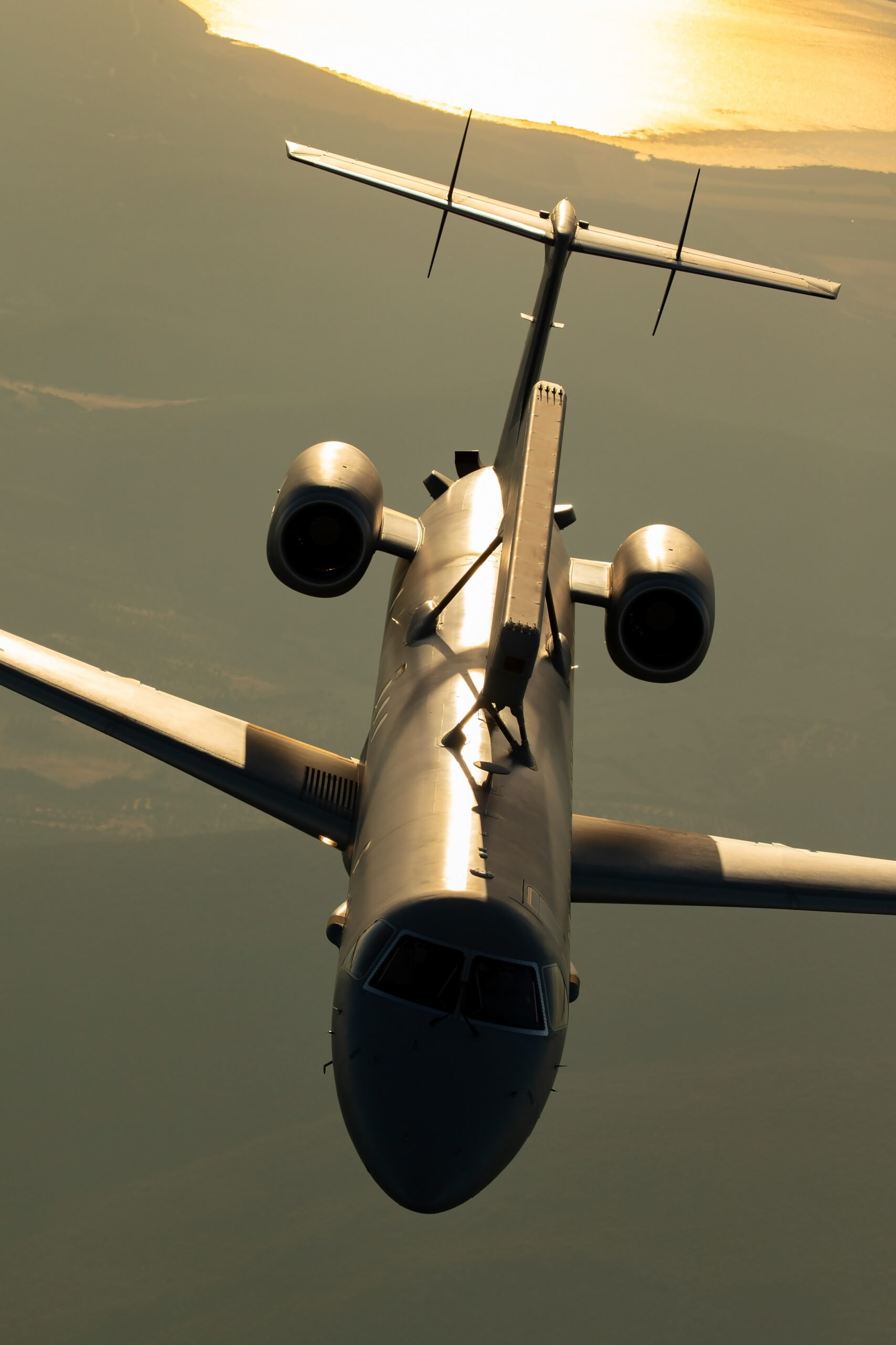 Hellenic Air Force Embraer EMB-145H AEW&C with dorsal Erieye radar, head-on in hazy golden backlight (portrait orientation)