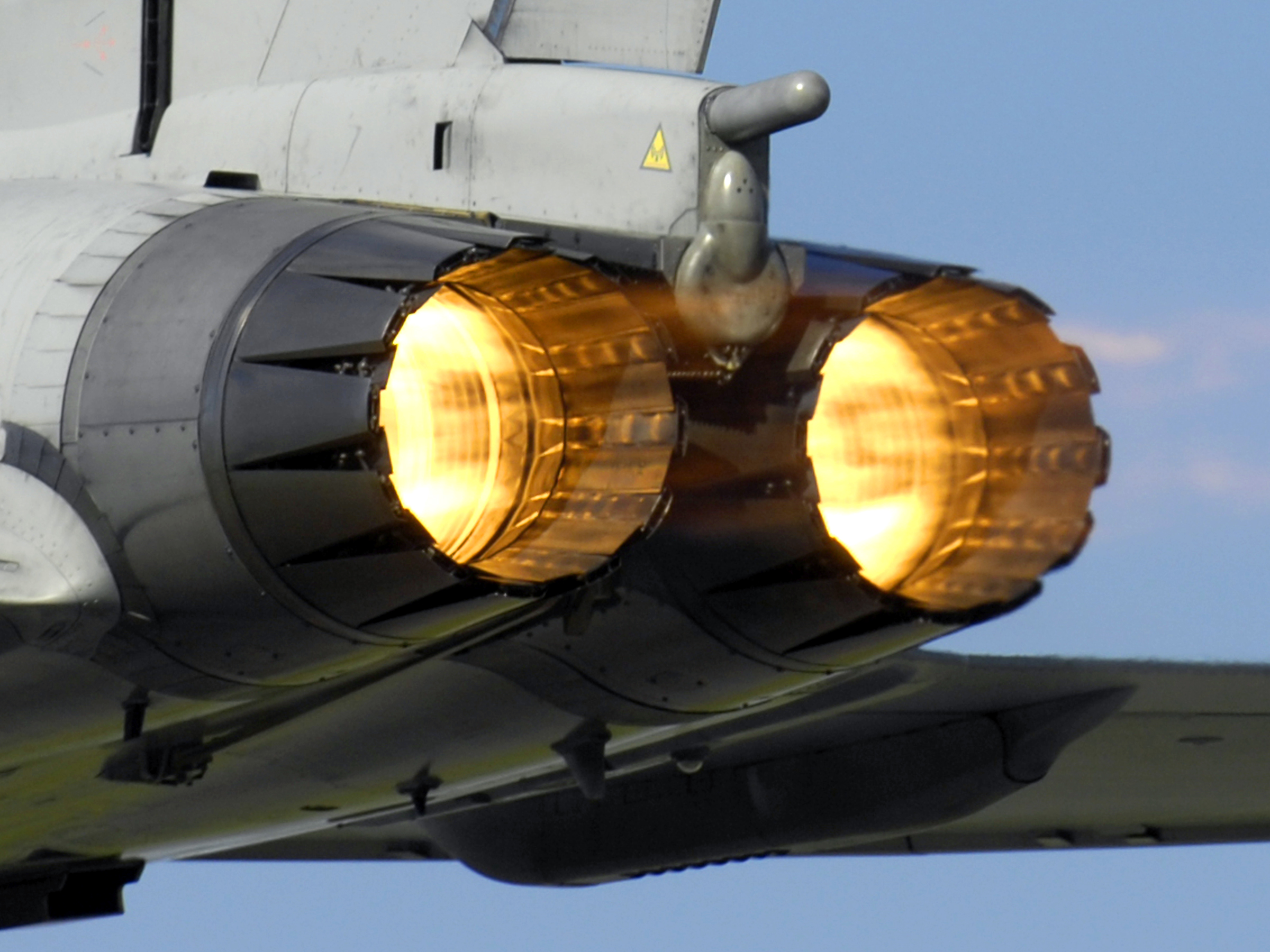 Eurofighter Typhoon igniting its afterburners on take-off from RAF Coningsby, hot exhaust distorting the air behind it