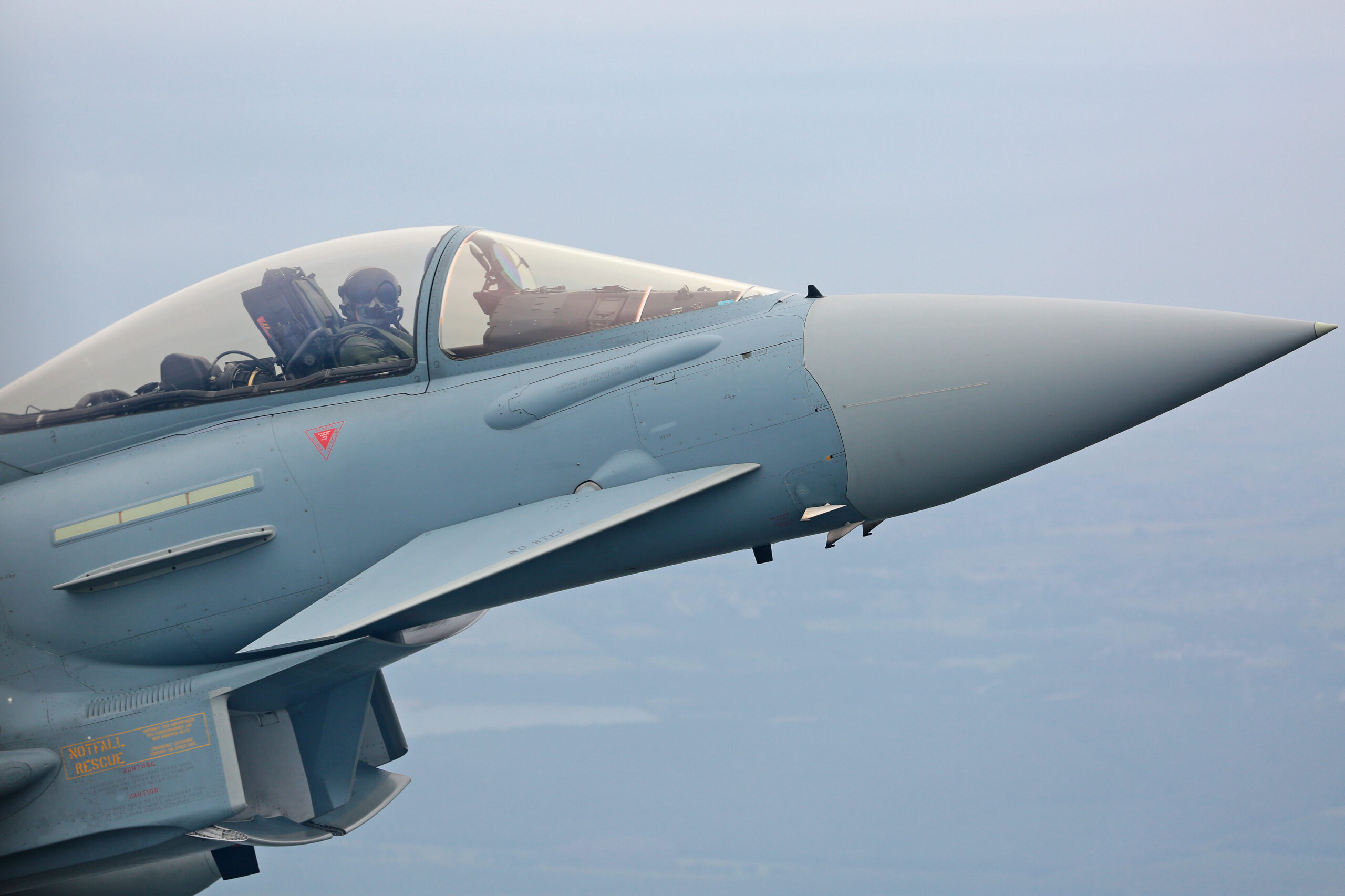 Close-up air to air view of a German Air Force Eurofighter Typhoon pilot and nose