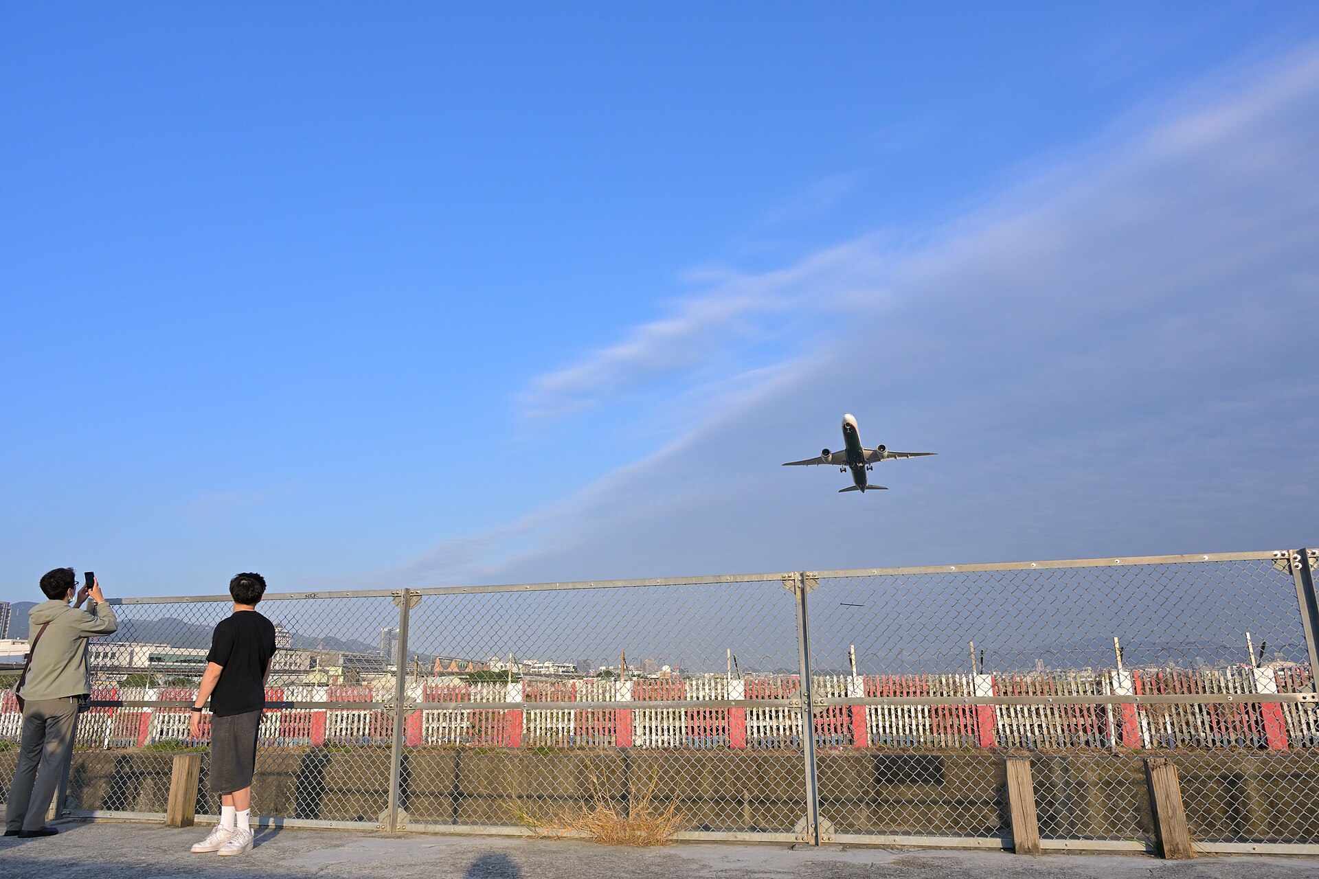 Plane spotters photographing an EVA Air Boeing 787-10 taking off at Taipei Songshan Airport