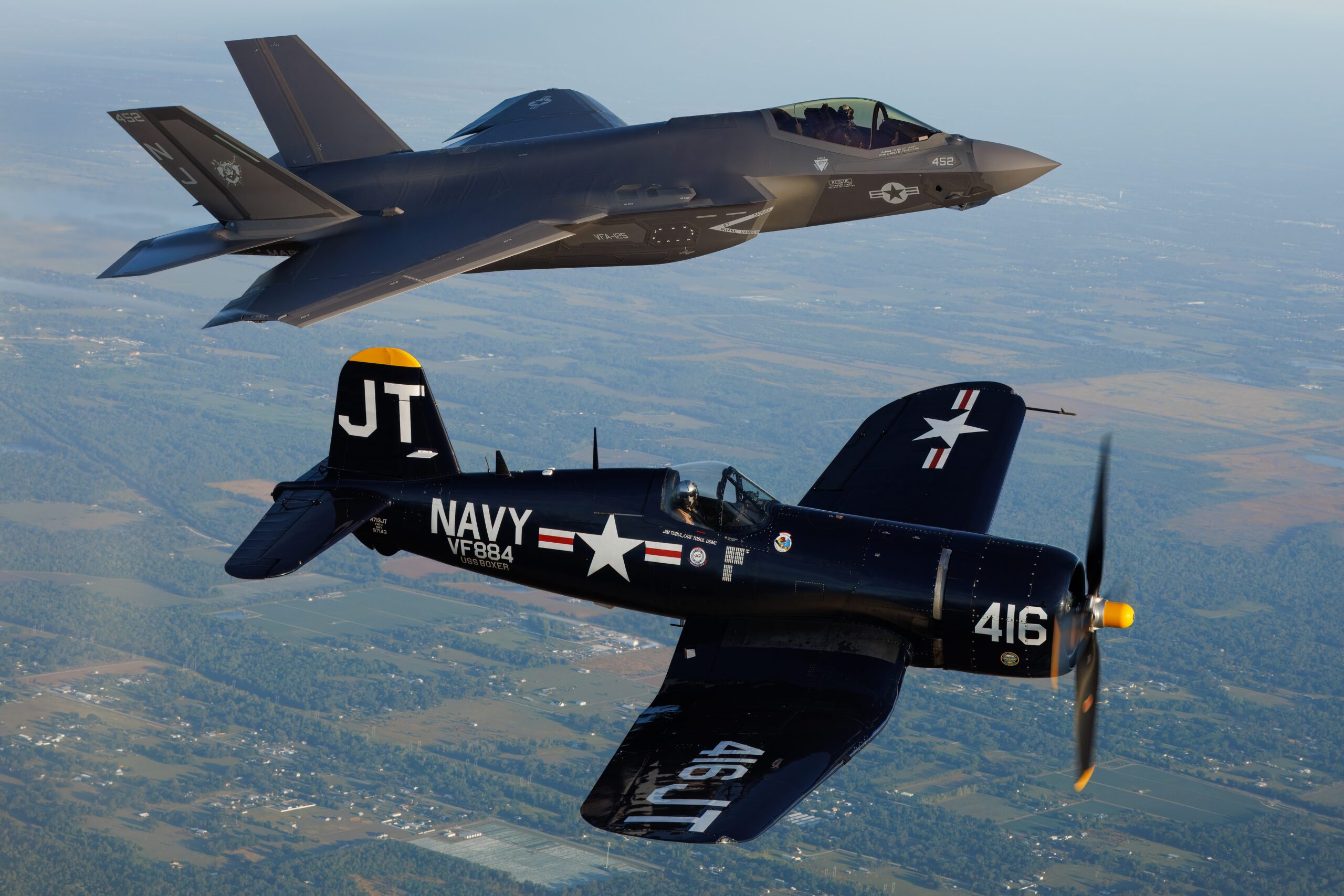 US Navy F-35C Lightning II of VFA-125 in heritage formation with a dark blue F4U-4 Corsair
