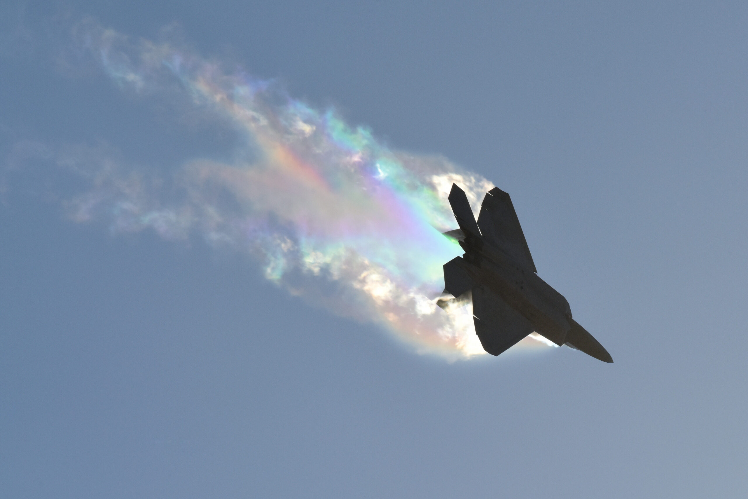 US Air Force F-22 Raptor pulling vapour in a hard banking turn