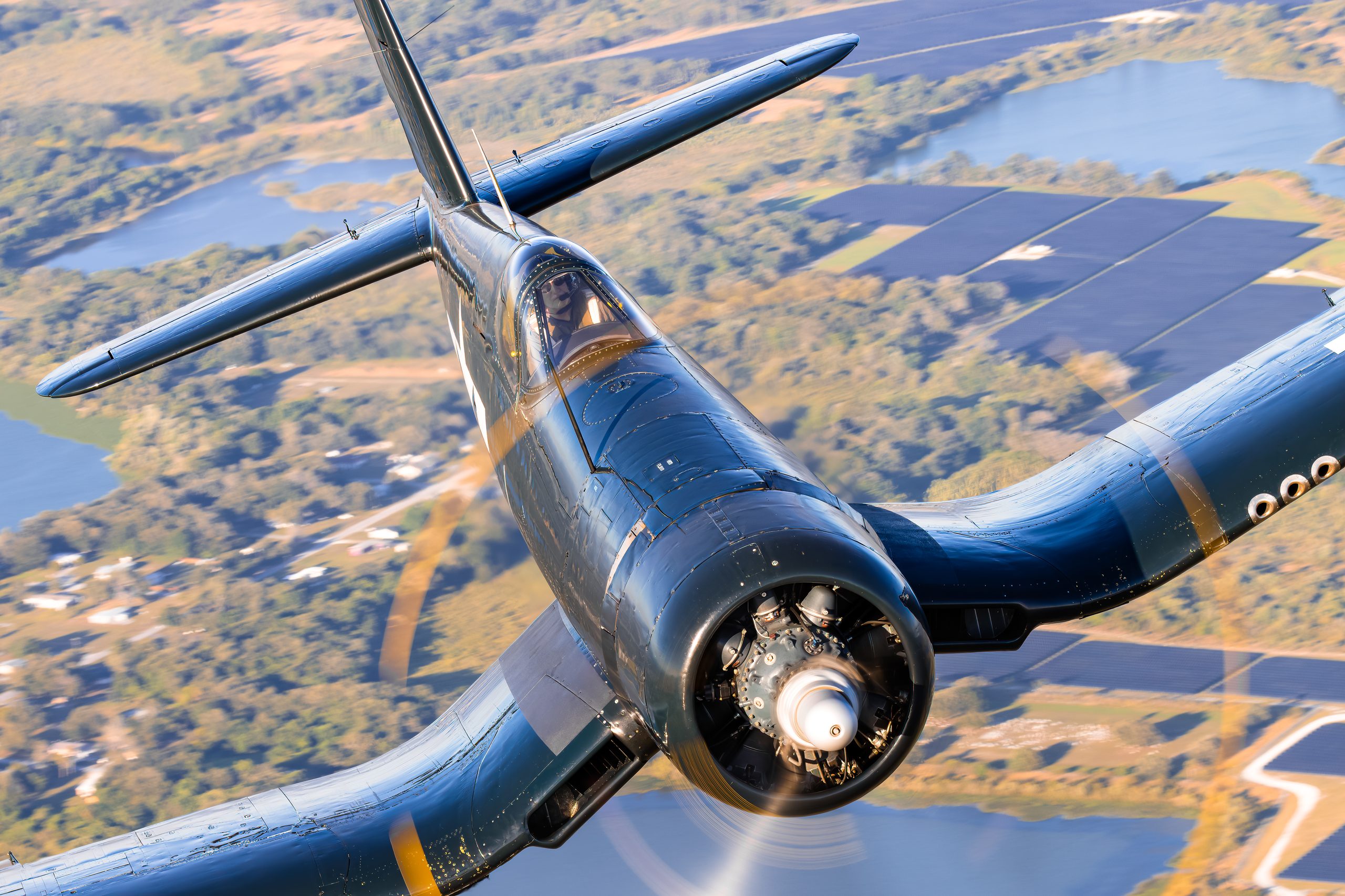 Close front-quarter view of a Goodyear FG-1D Corsair with blurred propeller