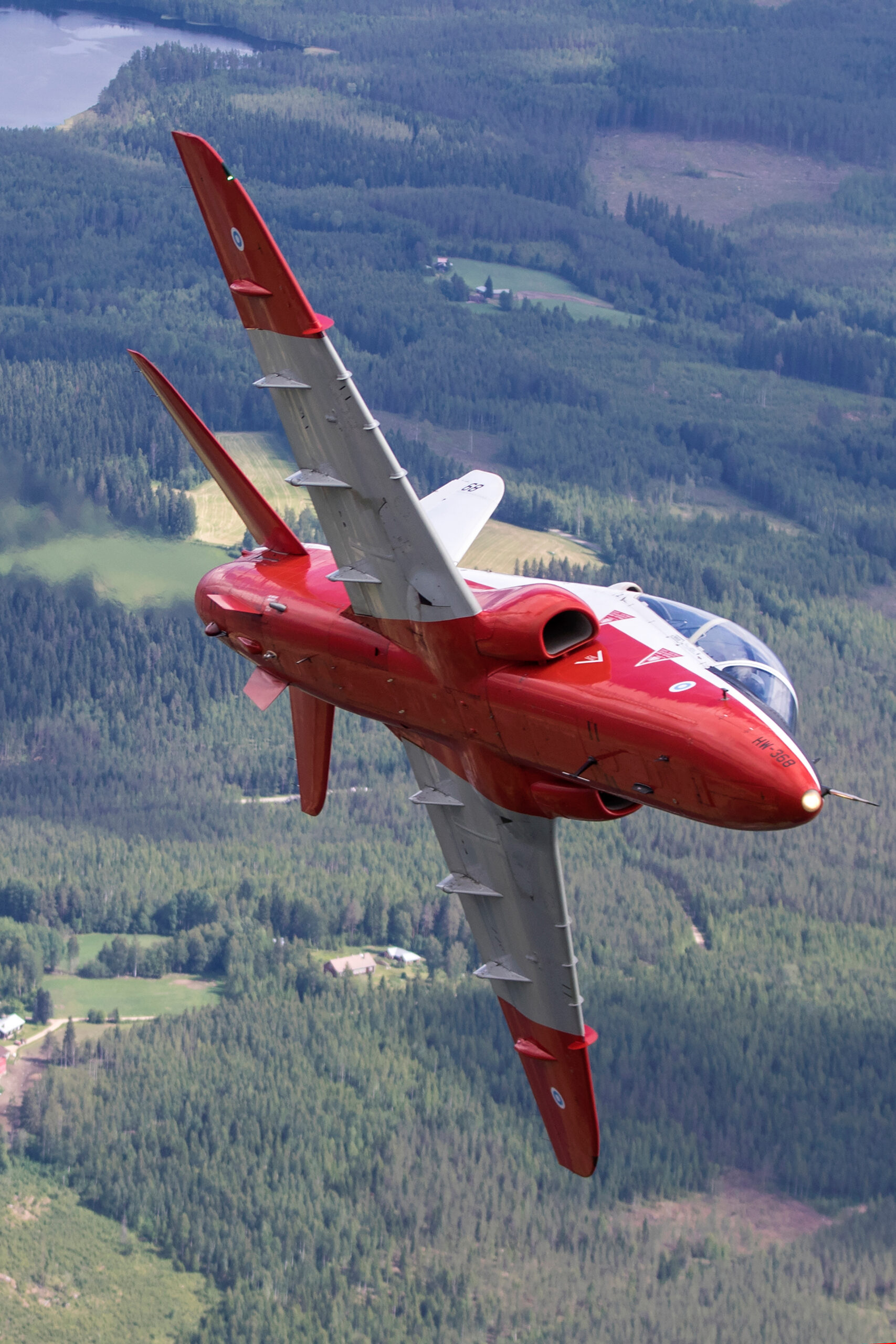 Red and white Finnish Air Force Hawk Mk.51A jet trainer banking to show its topside