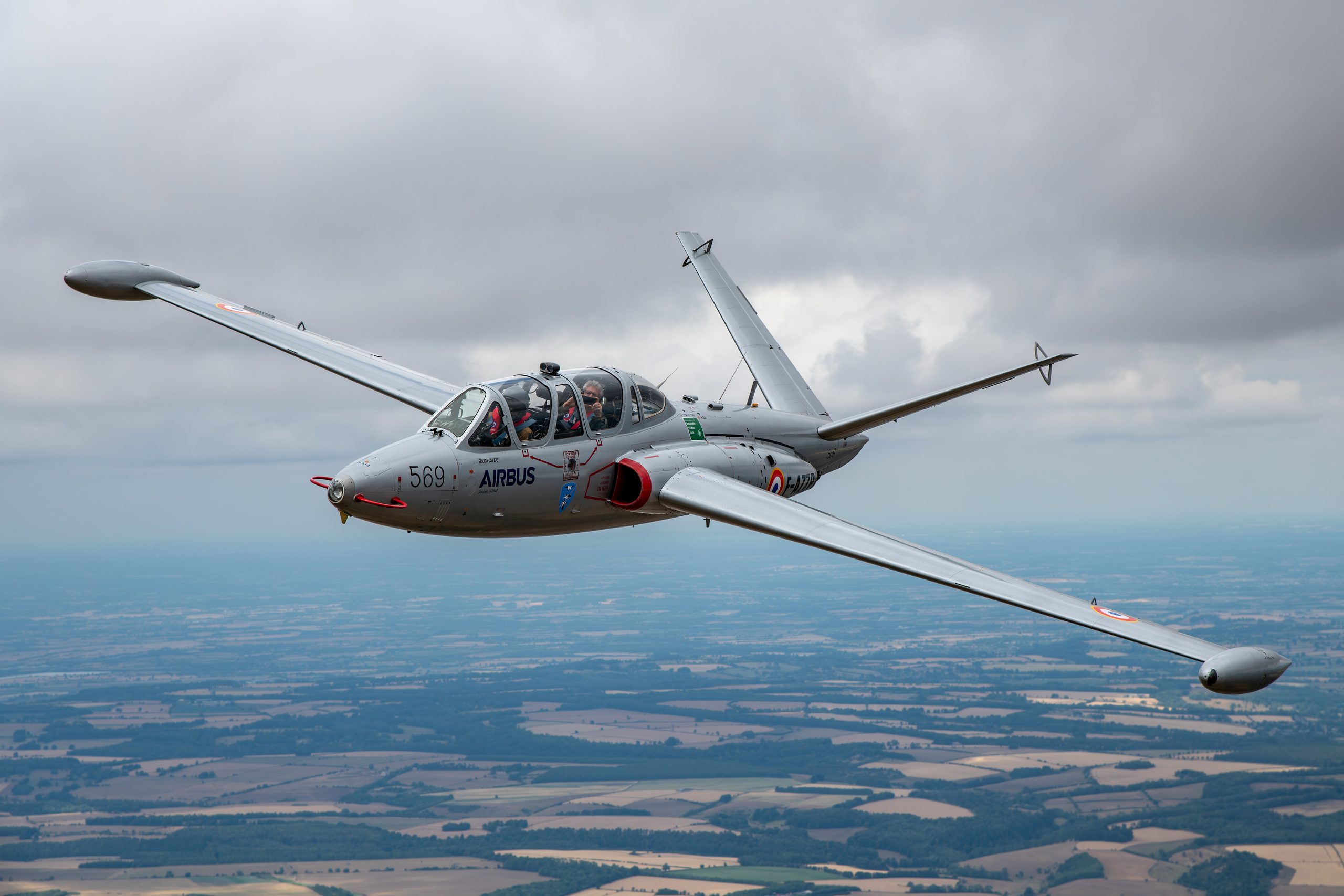 Silver Fouga CM-170R Magister jet trainer banking over farmland at RIAT