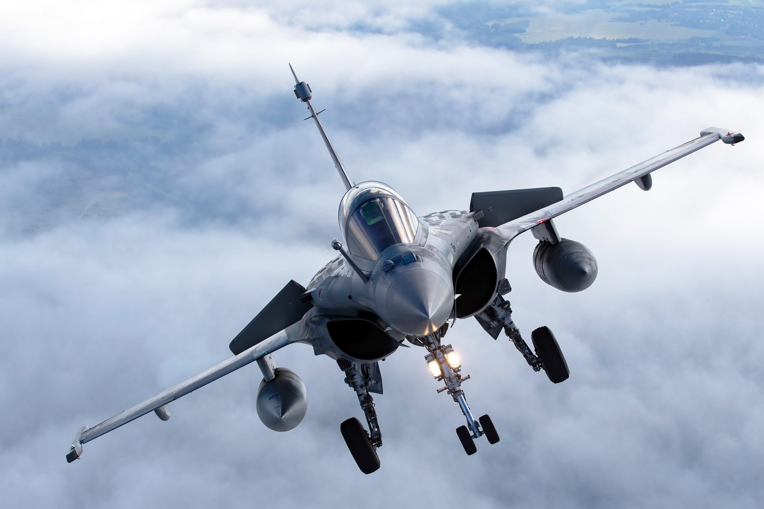 French Air Force Dassault Rafale banking over cloud