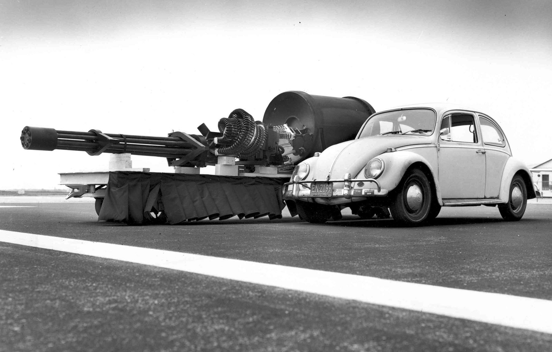 The GAU-8/A Avenger 30mm cannon displayed next to a Volkswagen Beetle for size comparison