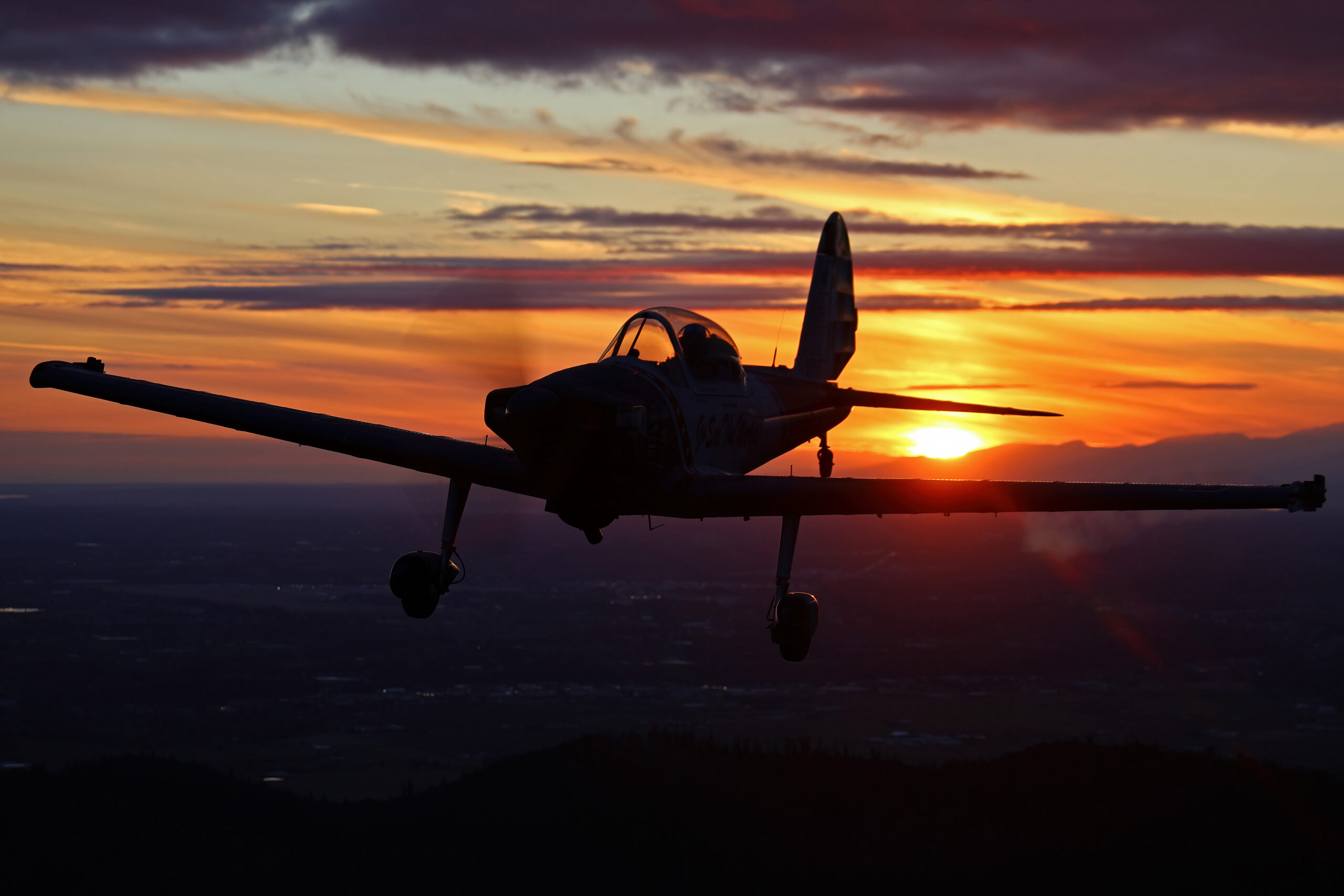 GhostWriter Super Chipmunk silhouetted against a dramatic orange and purple sunset