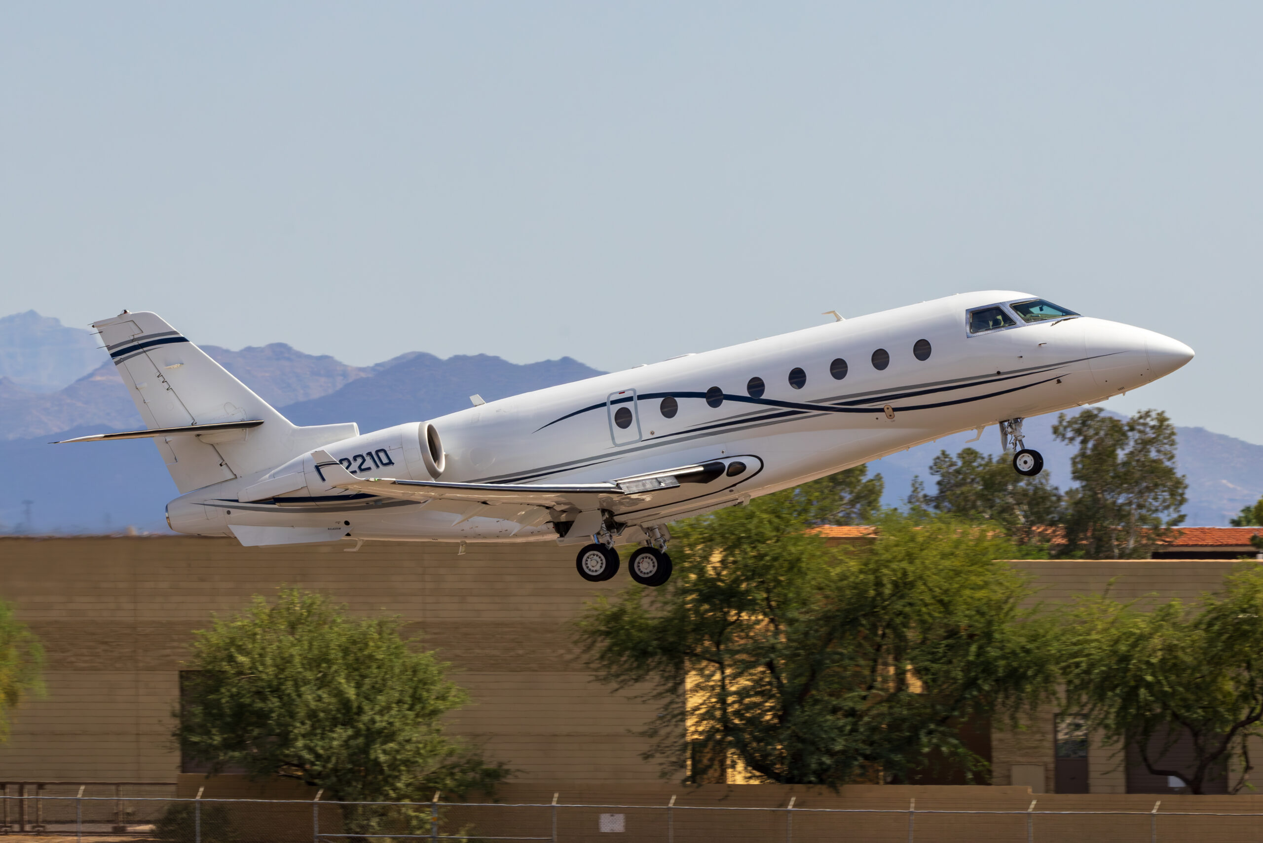 IAI 1126 Galaxy Gulfstream G200 business jet lifting off with desert mountains behind