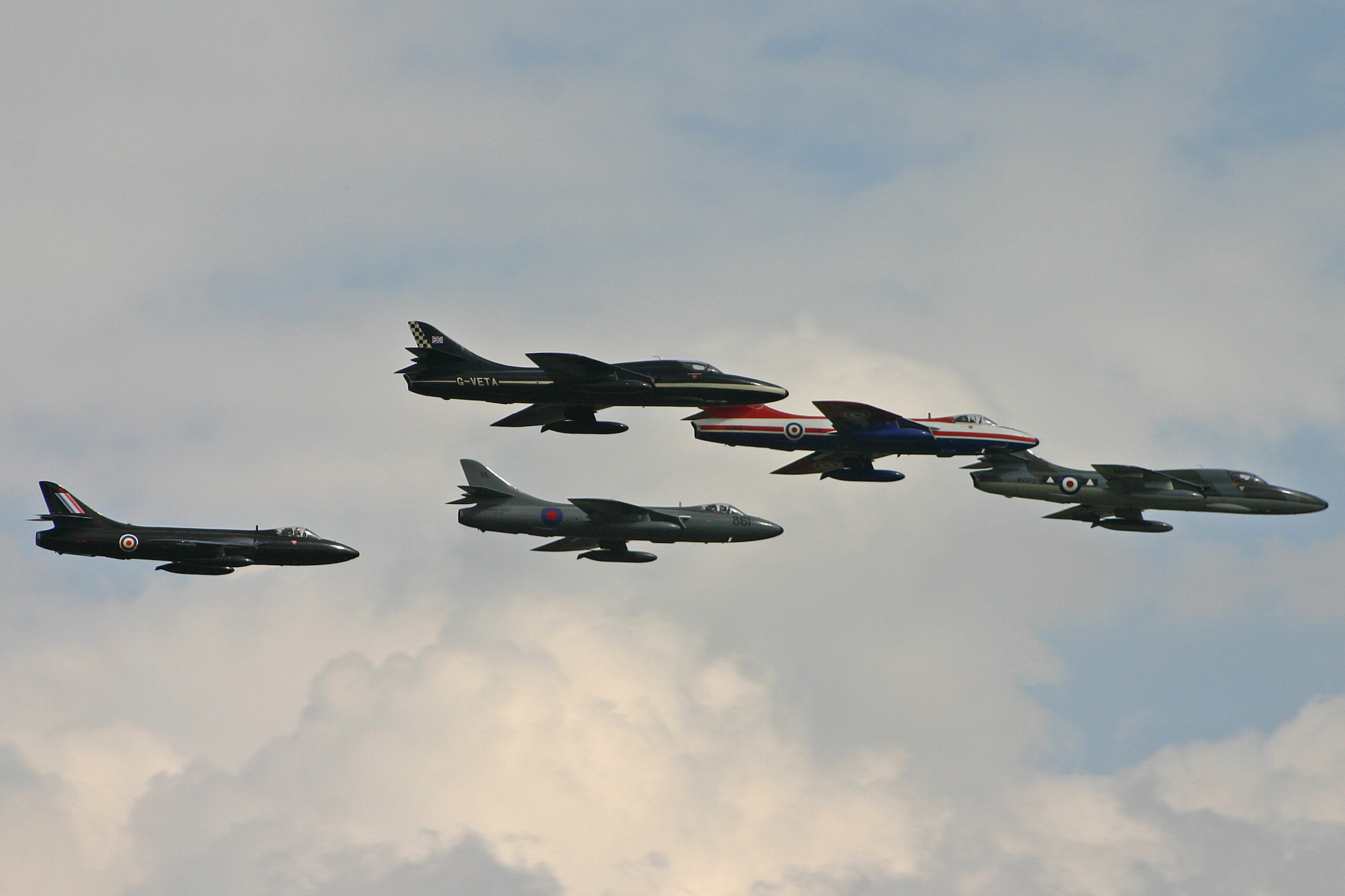 Formation of five Hawker Hunter jet fighters flying together at an airshow