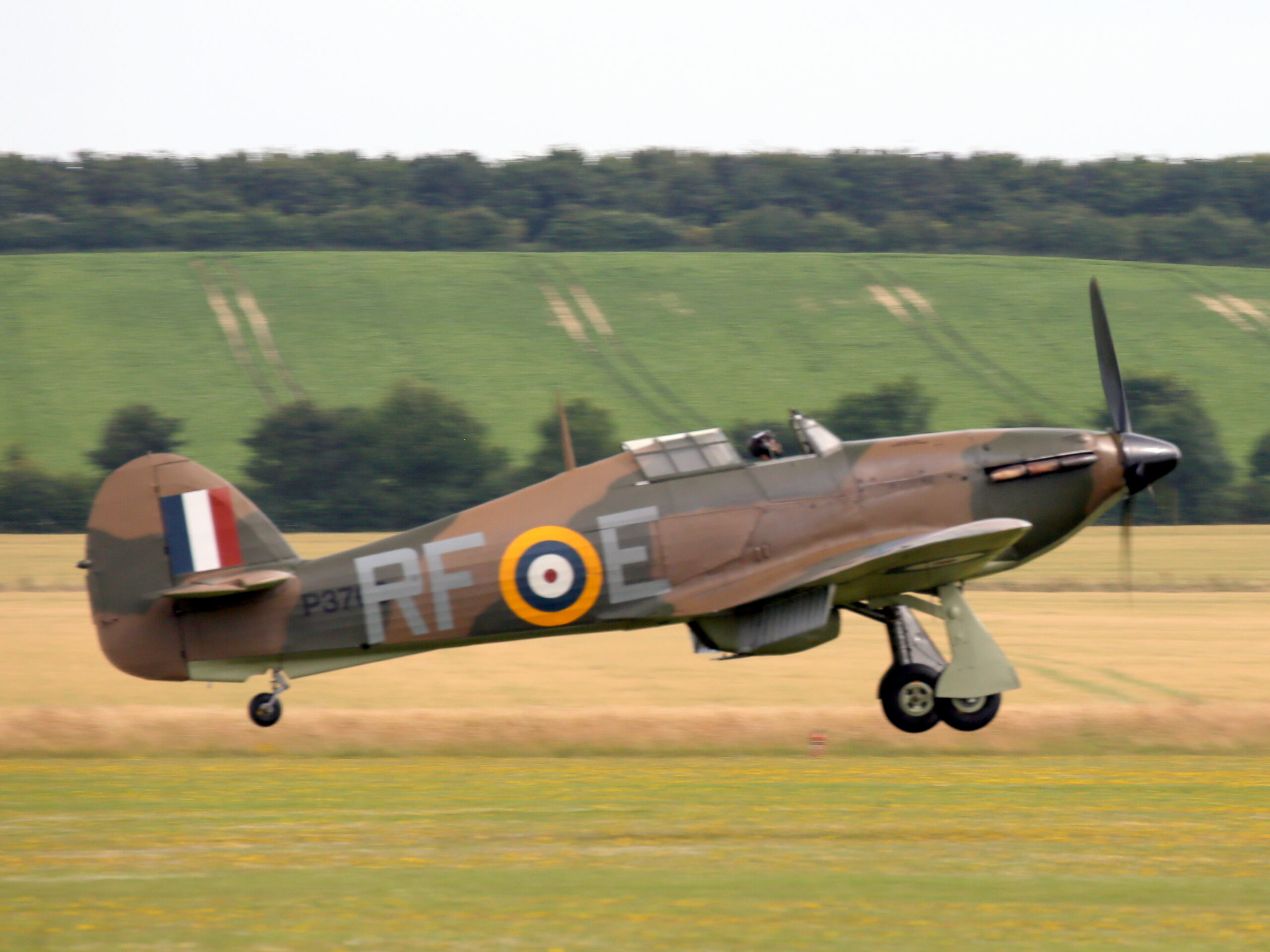 Airworthy Hawker Hurricane Mk XII banking in flight at an airshow