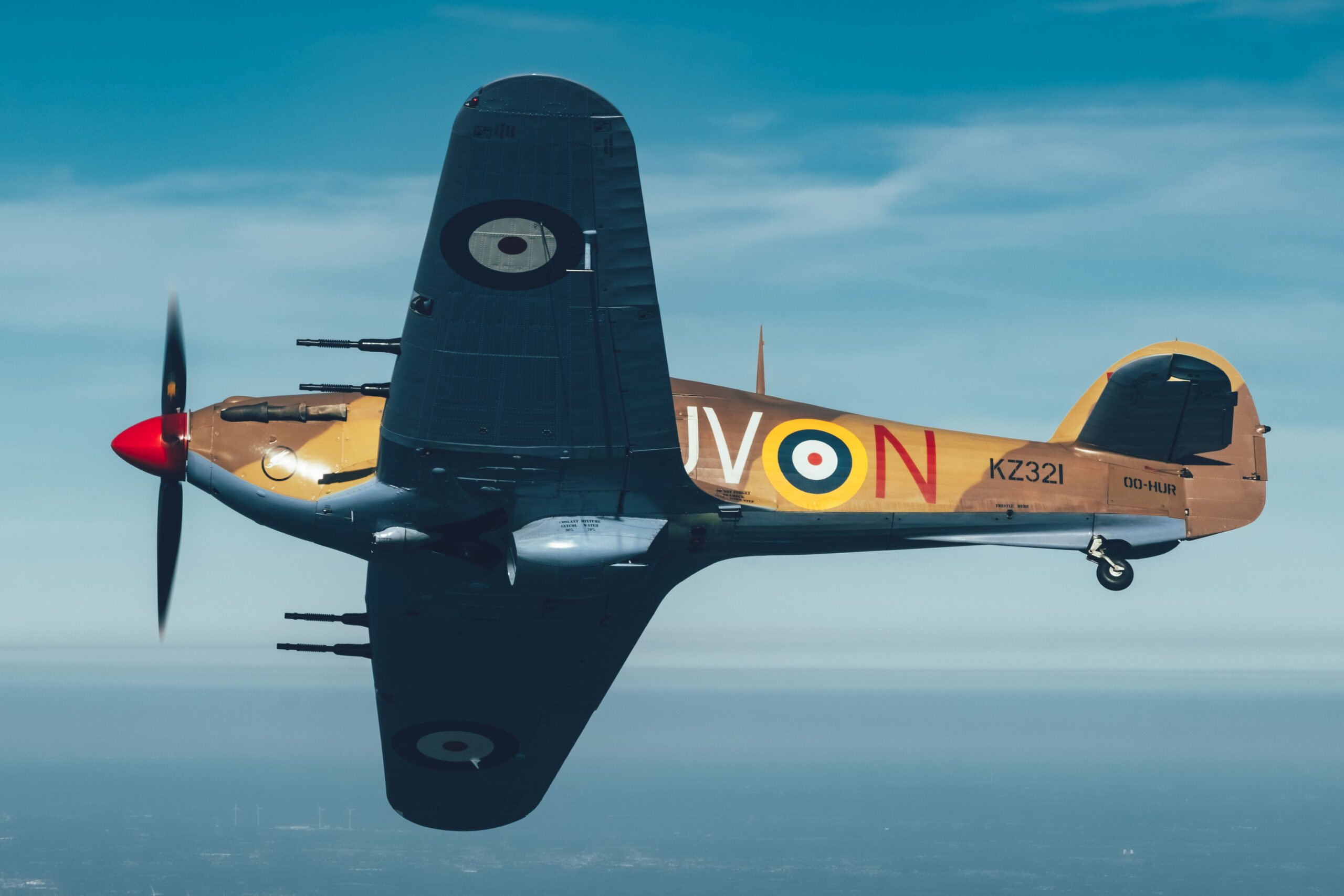 Hawker Hurricane Mk4 KZ321 banking to show its full topside air to air against blue sky