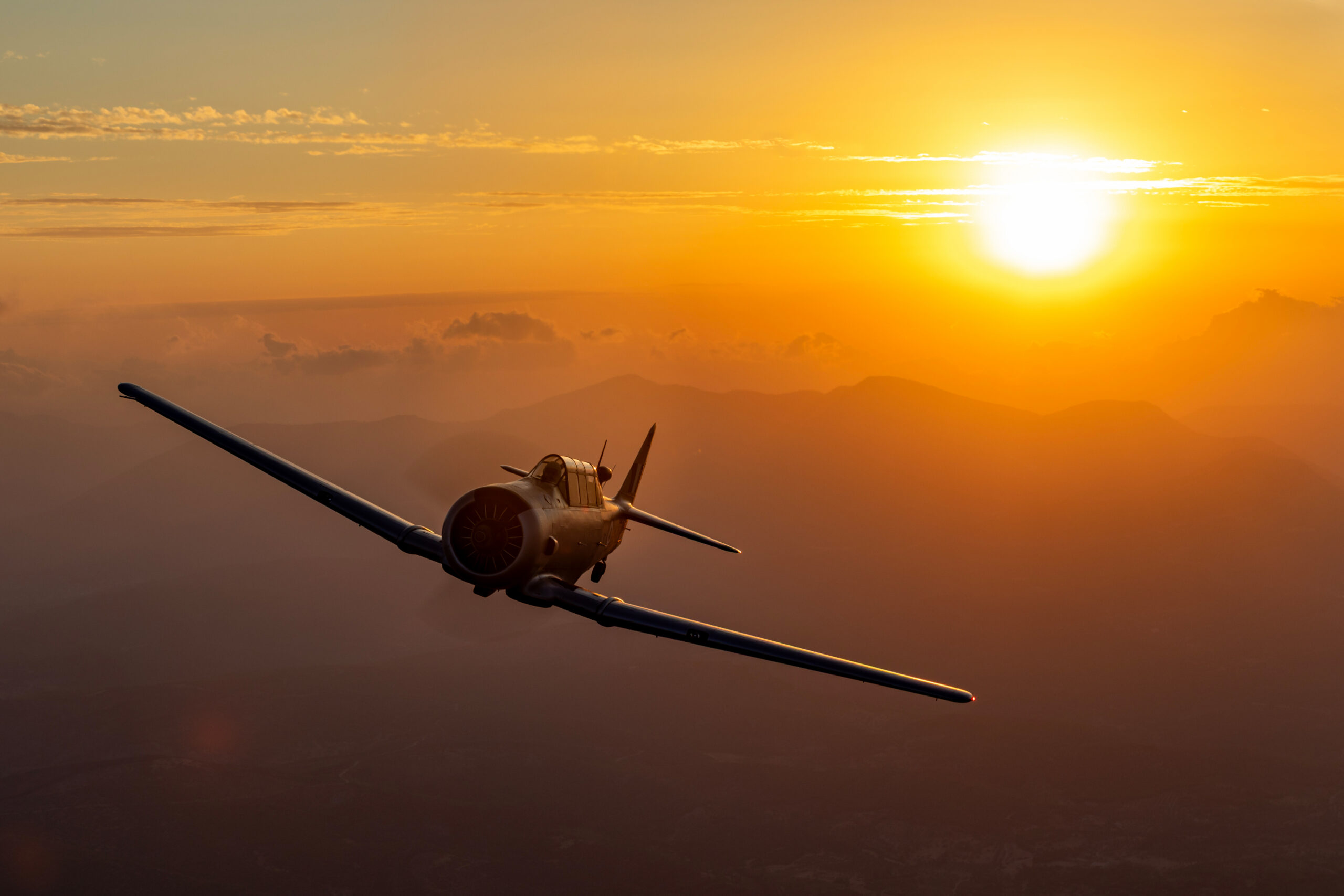 Hellenic Air Force T-6G Texan flying towards a golden sunset