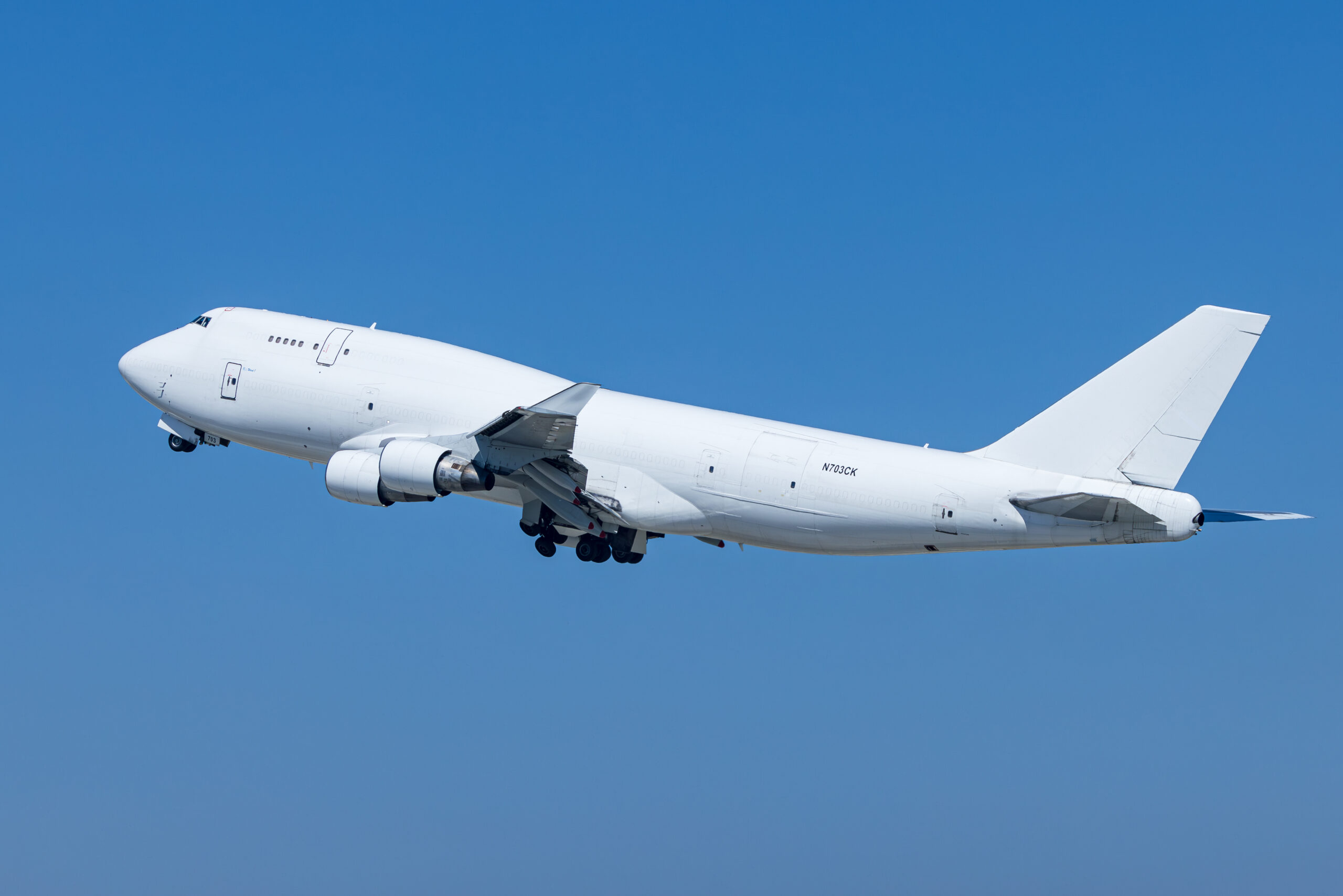 All-white Kalitta Air Boeing 747-400 converted freighter N703CK climbing out of Los Angeles with gear still down