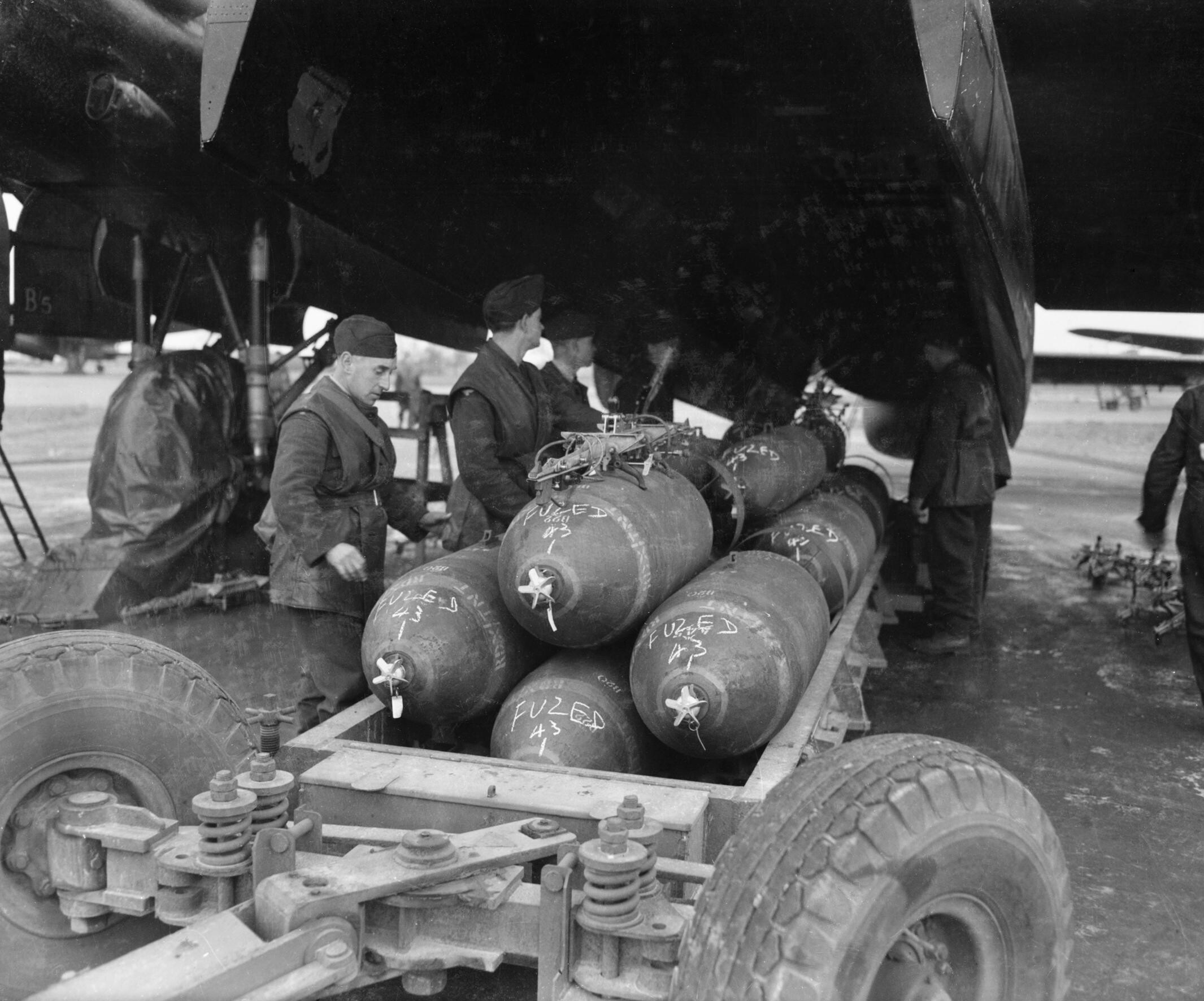 Armourers loading bombs into a No. 106 Squadron Lancaster at RAF Metheringham