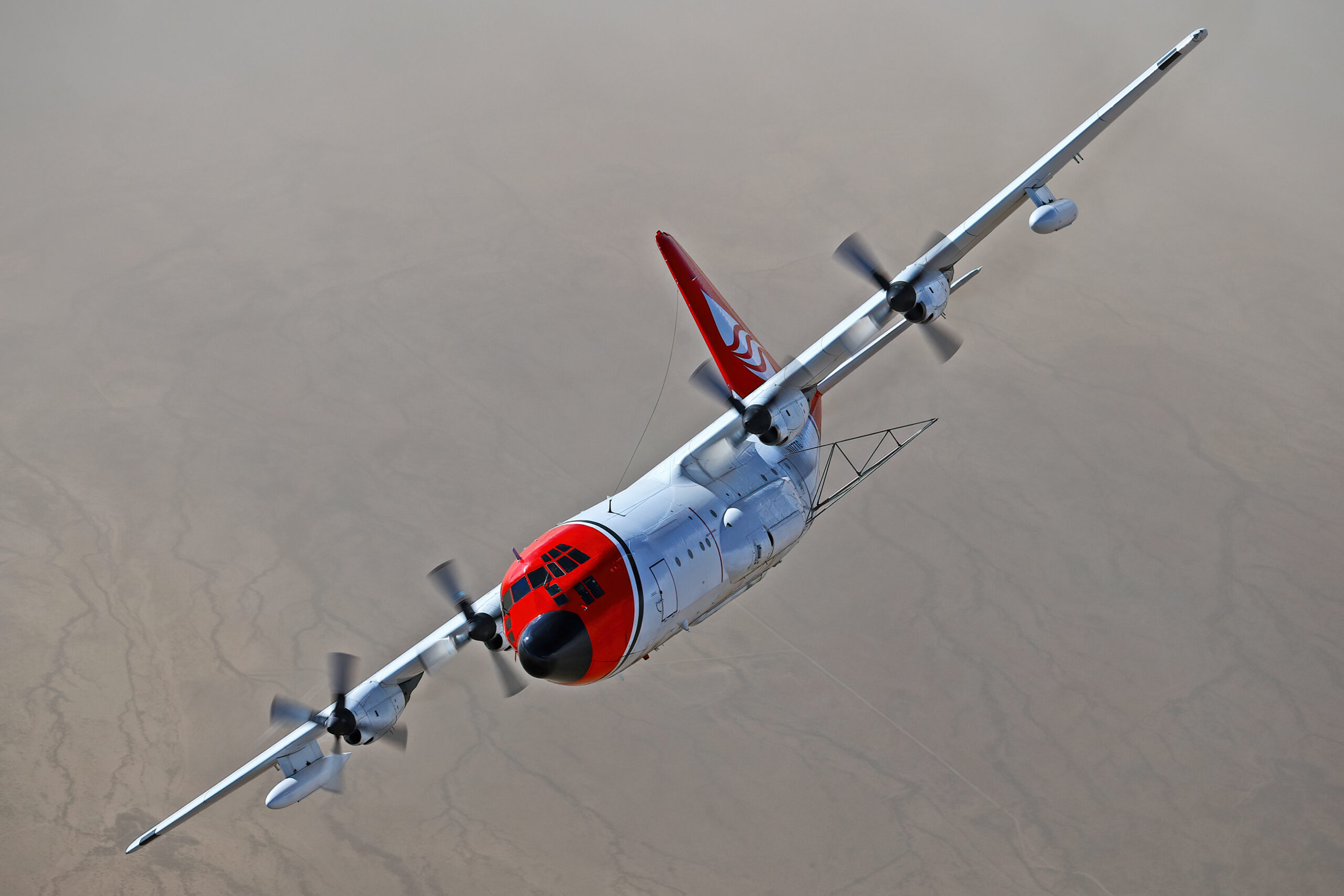 Lockheed C-130A Hercules N117TG air tanker photographed air to air over Arizona desert