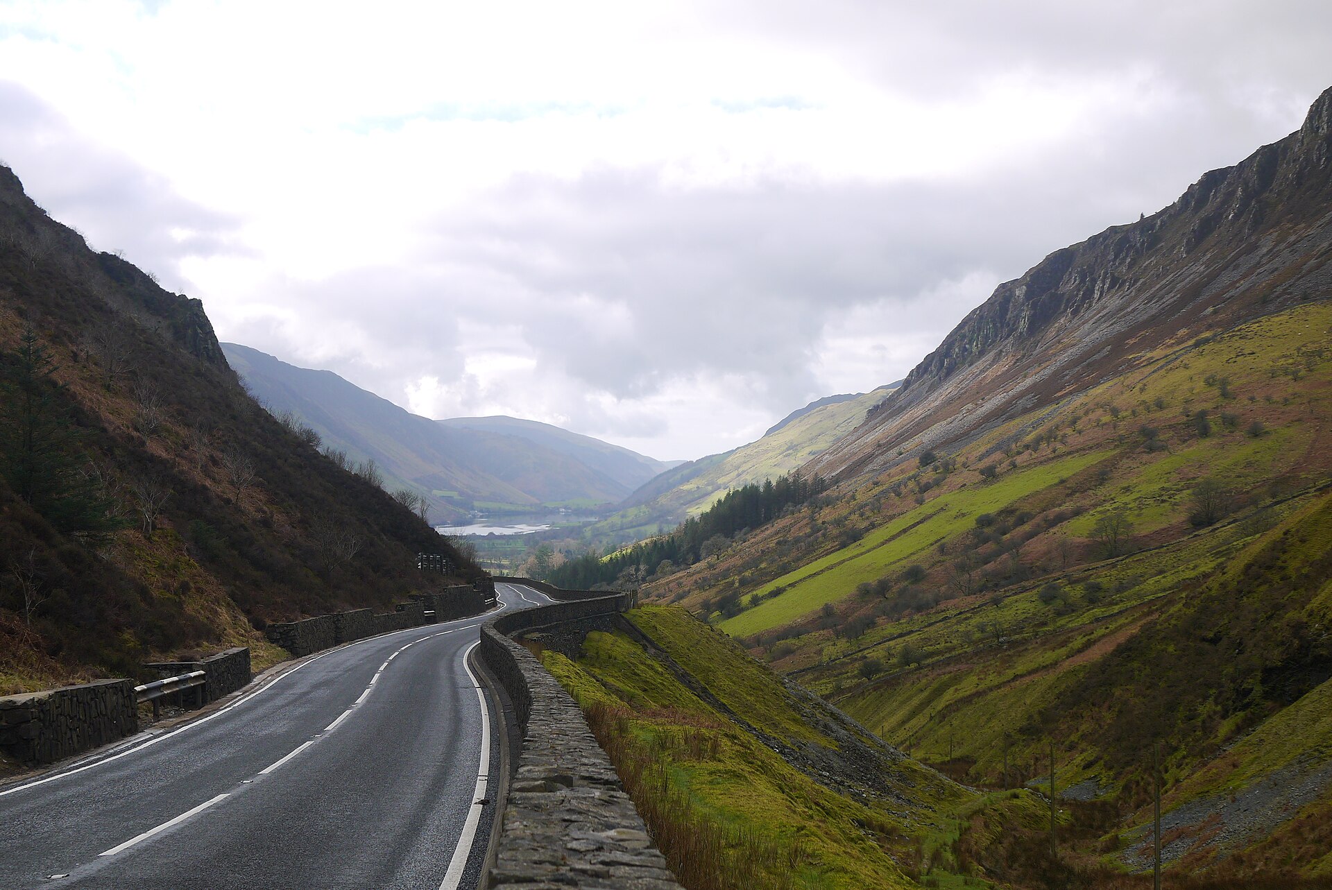 The mountain road pass through the Mach Loop valleys in Wales with steep hillsides either side