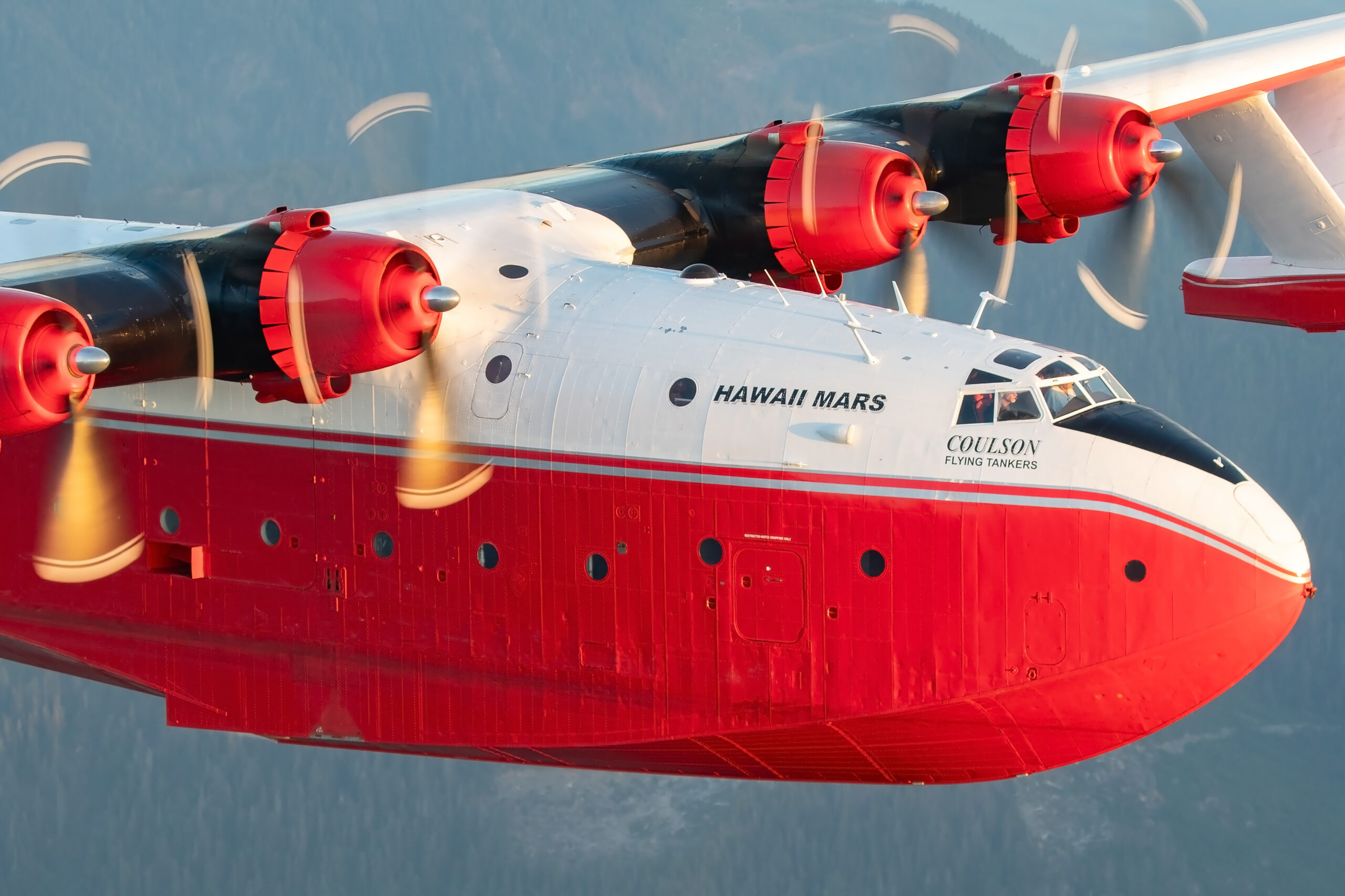 Close-up of the Martin Mars flying boat cockpit and engines in sunset light